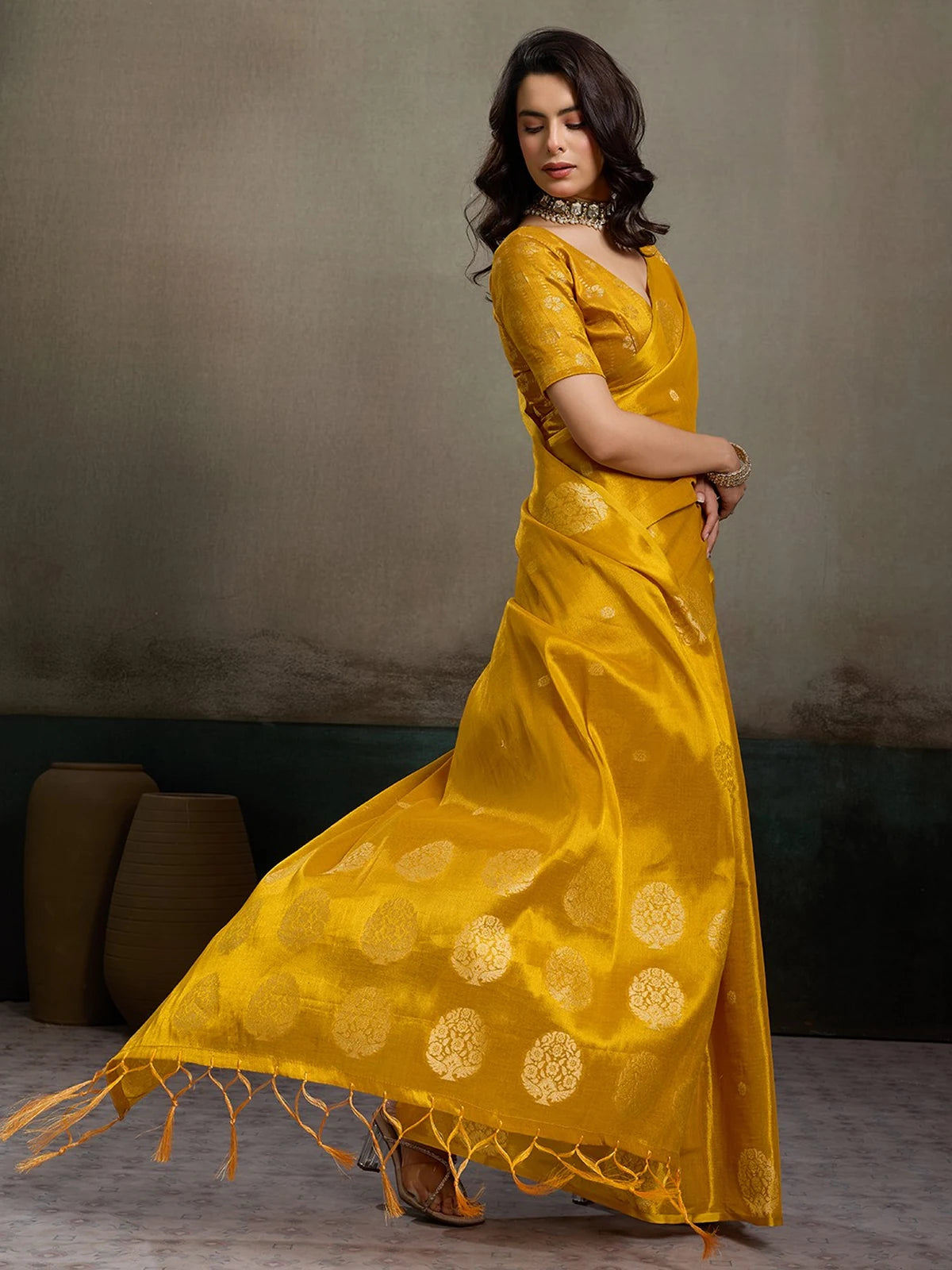 Tarani mustard tissue silk saree Shefali side view with woven motifs and blouse