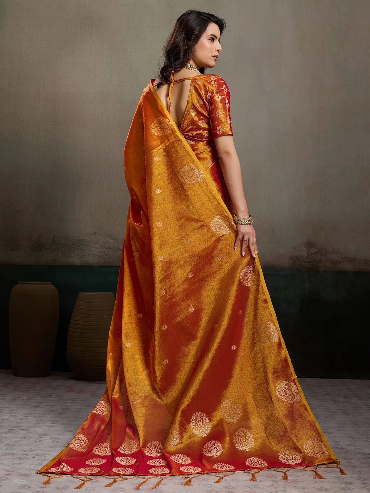 Tarani Baharika red tissue silk saree back view showcasing graceful drape and pallu