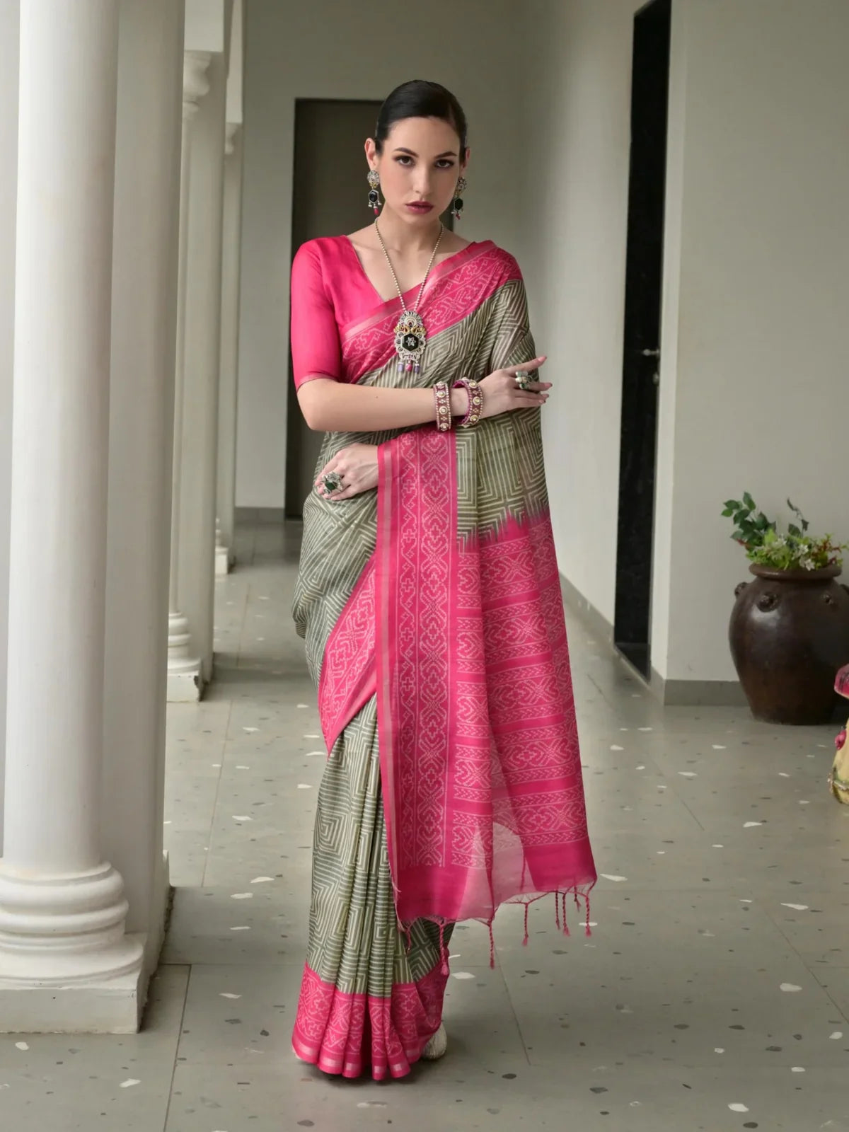 Tarani green tussar silk saree with pink border and full front view worn by model