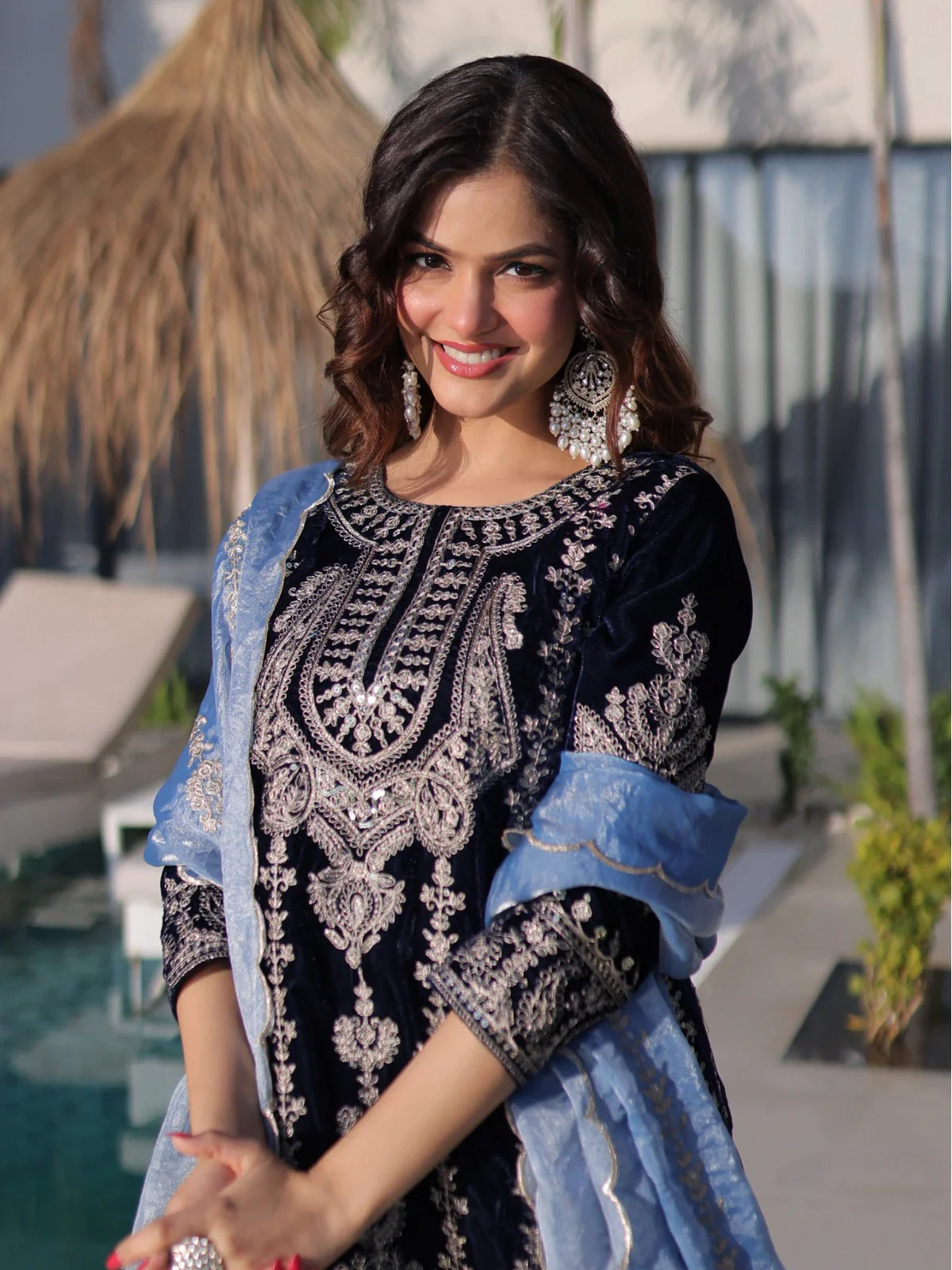 Tarani navy blue velvet dress upper body closeup showing bell sleeves and embroidered neckline