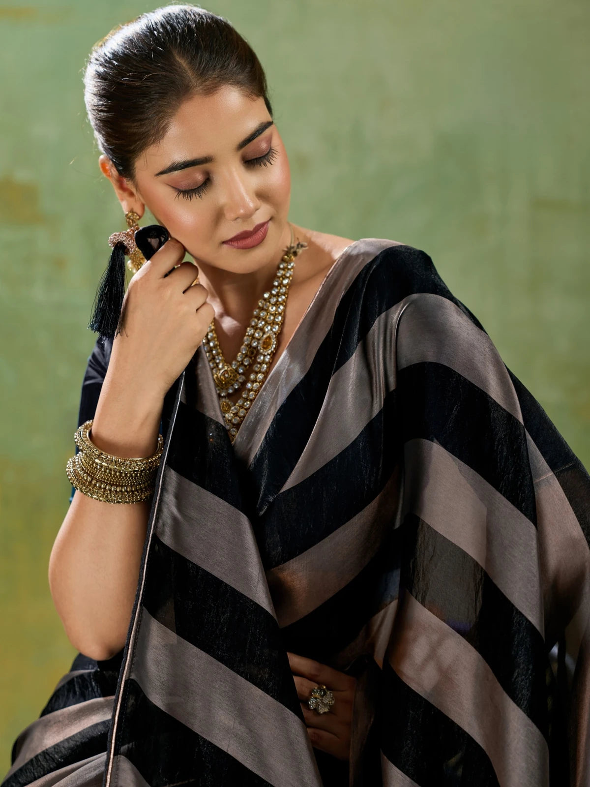 Tarani closeup of black velvet satin saree with metallic gold patta detailing