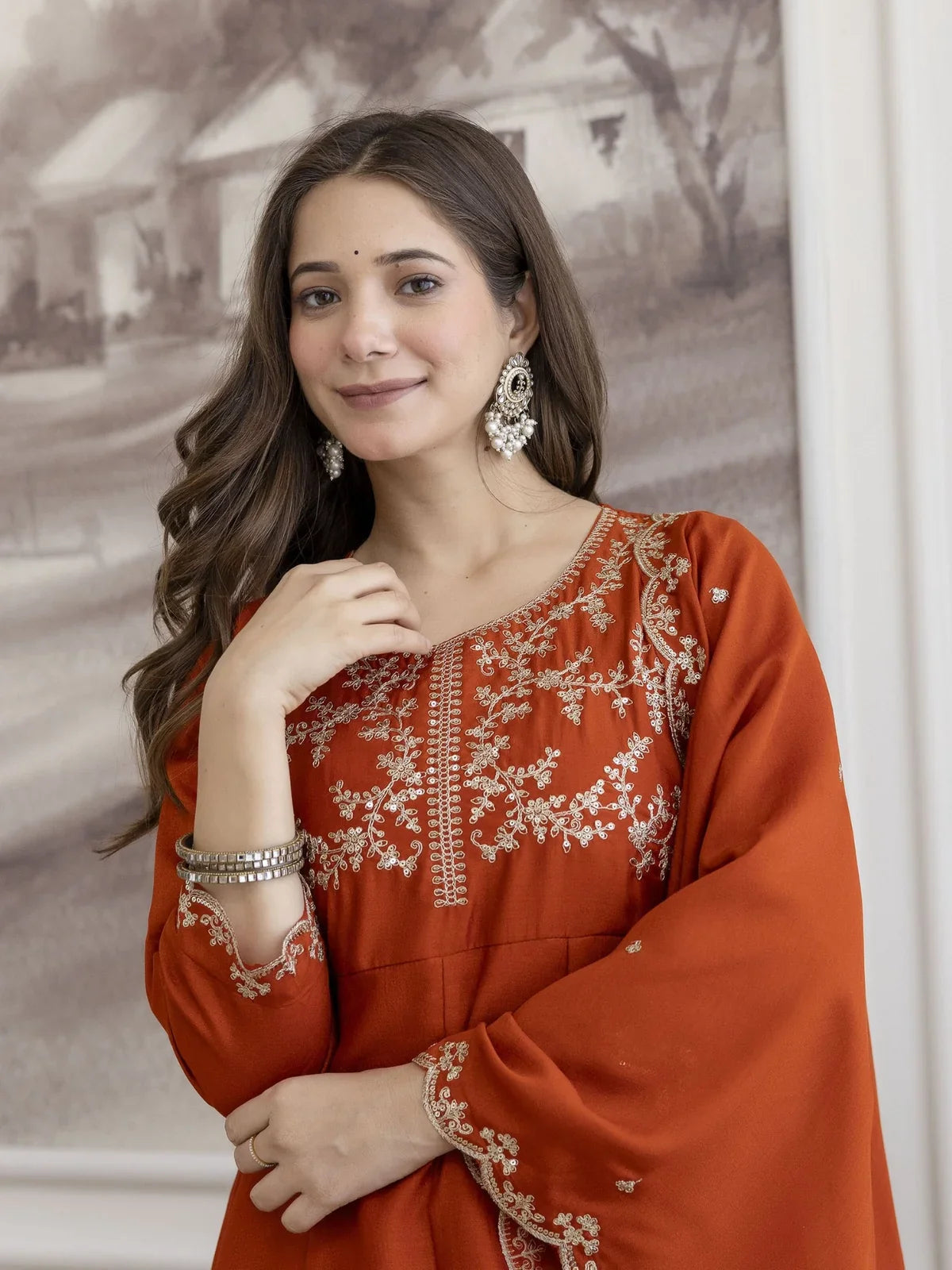 Tarani orange vichitra silk dress closeup showing embroidery on neckline and sleeves in upper body view