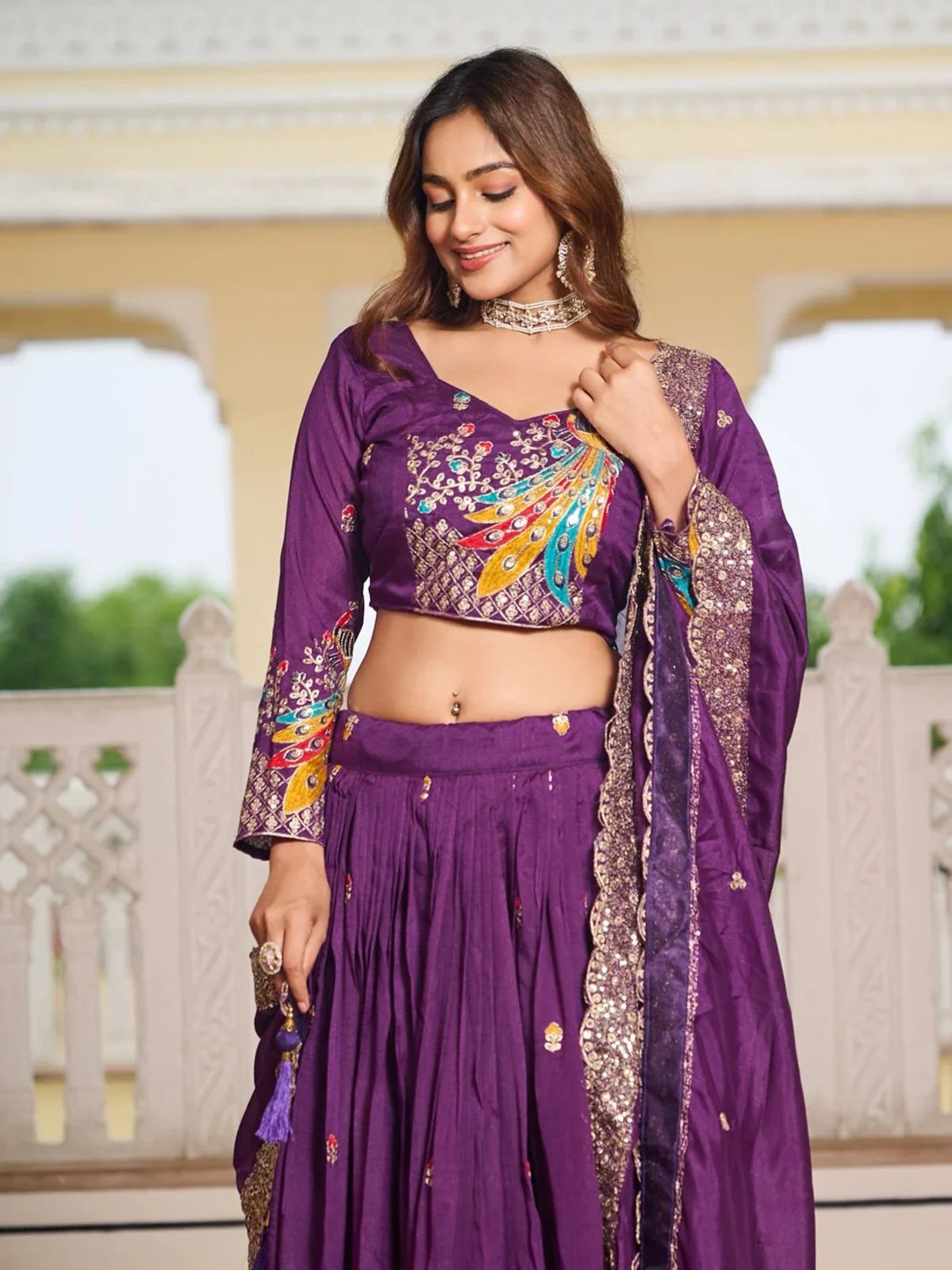Tarani purple lehenga upper body view with embroidered blouse and neckline design