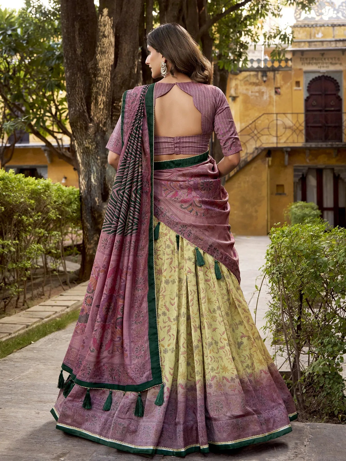 Tarani yellow lehenga back view showcasing printed dupatta and open back blouse