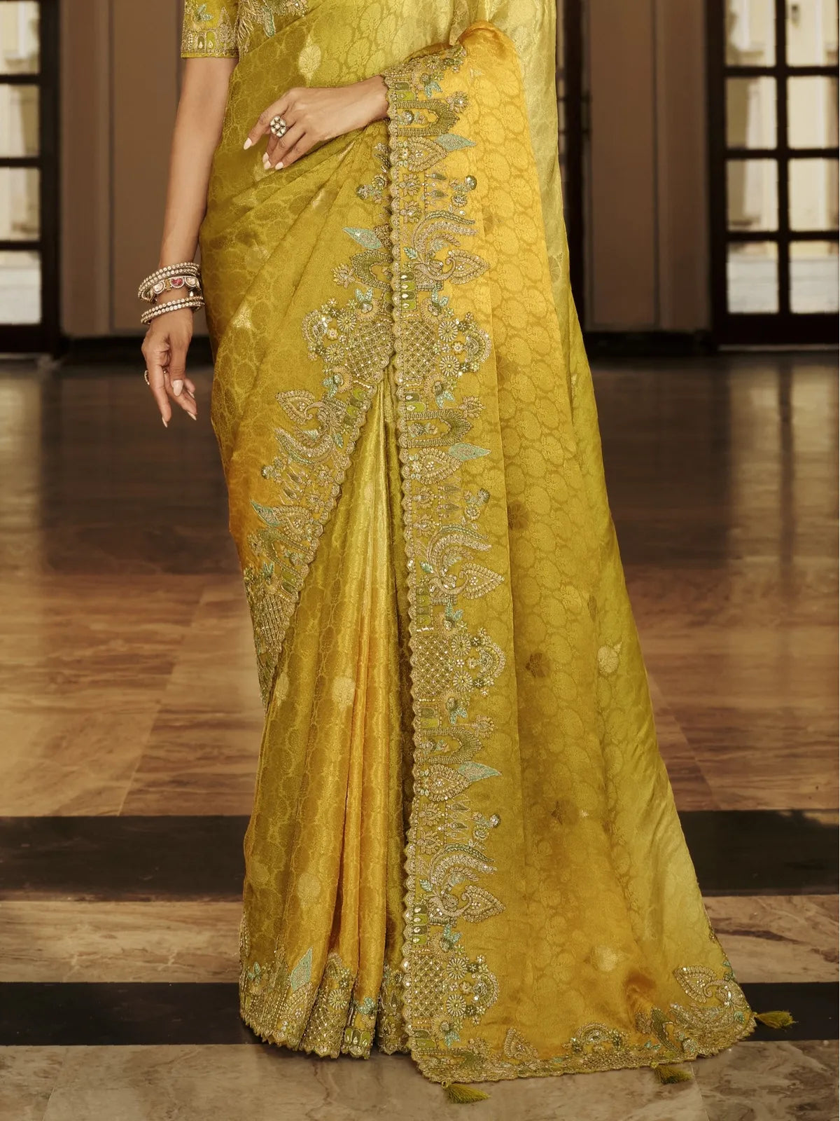Tarani yellow viscose jacquard saree close view of pallu and embroidered border with tassels