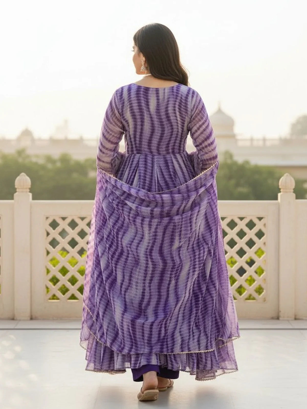 Tarani back view of purple printed dress showing soft flow and festive charm