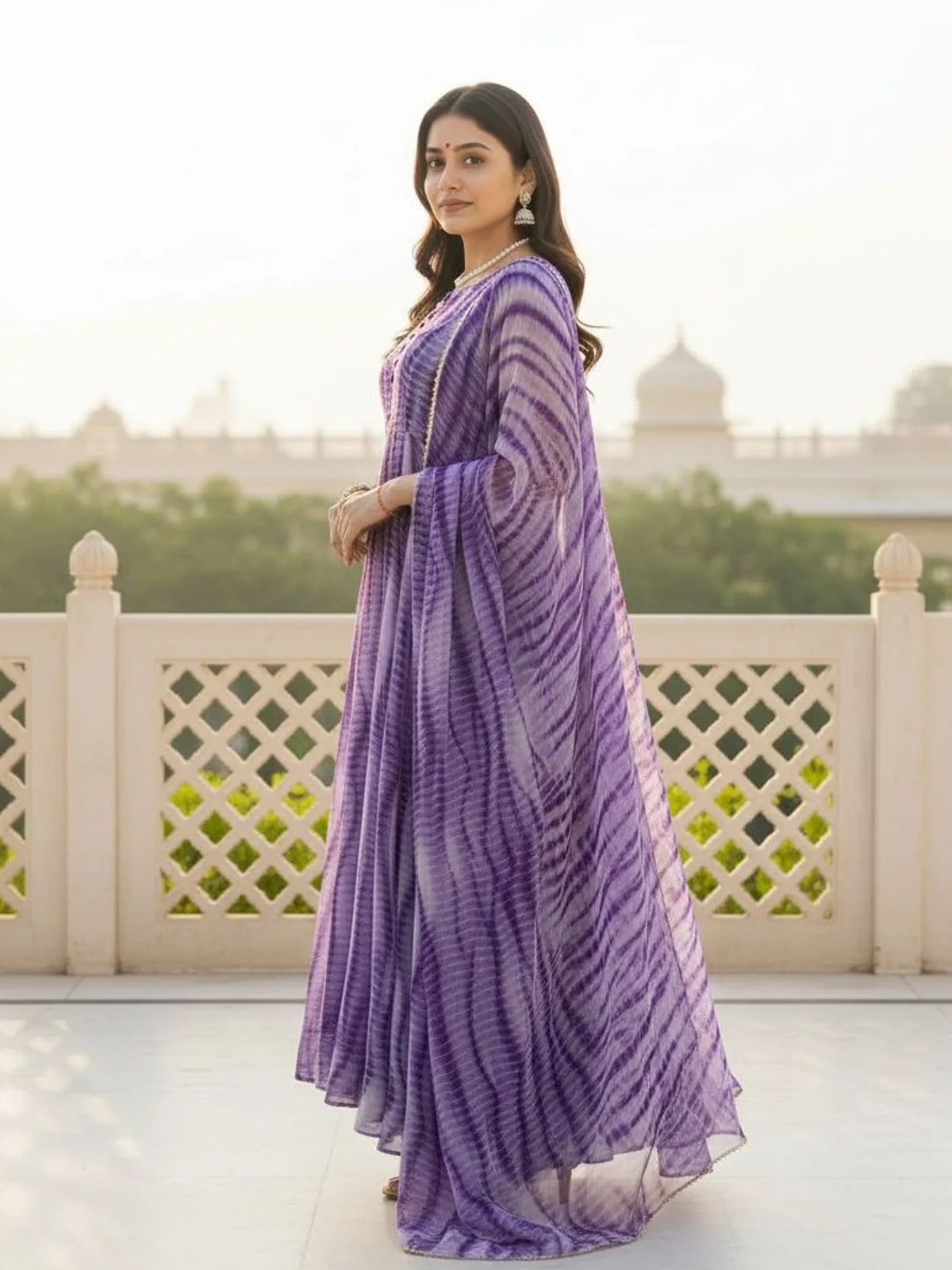Tarani side pose of purple weightless dress with traditional detailing and sheer dupatta