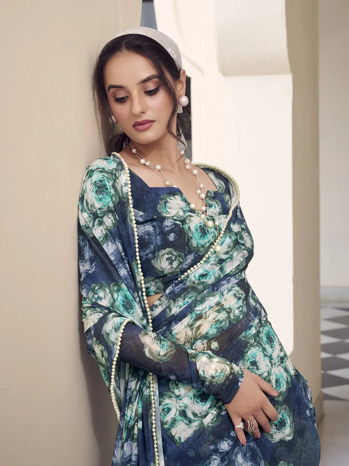 Tarani upper body view of green weightless marbal saree showing soft floral pattern and elegant drape