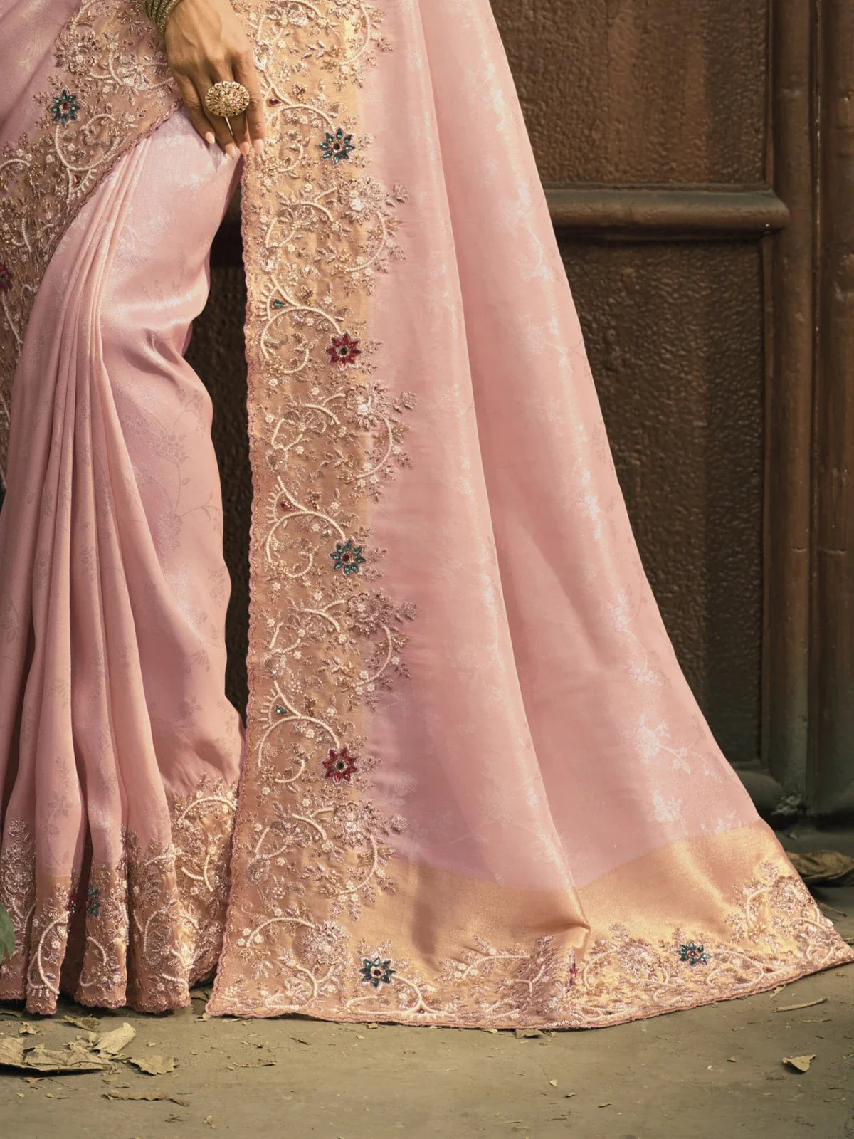 Tarani closeup view of pink zarif silk saree with intricate emerald heavy border work