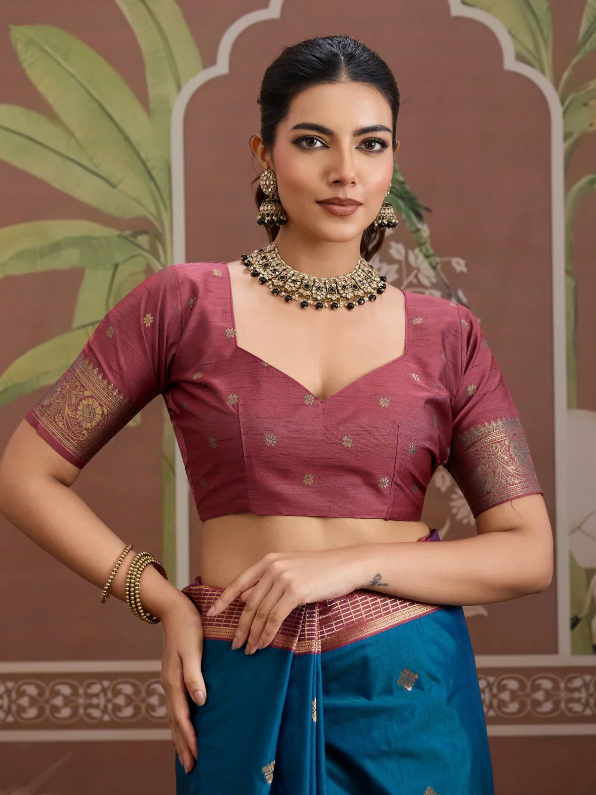 Tarani blue silk saree with rich maroon blouse and elegant jewellery in upper body view