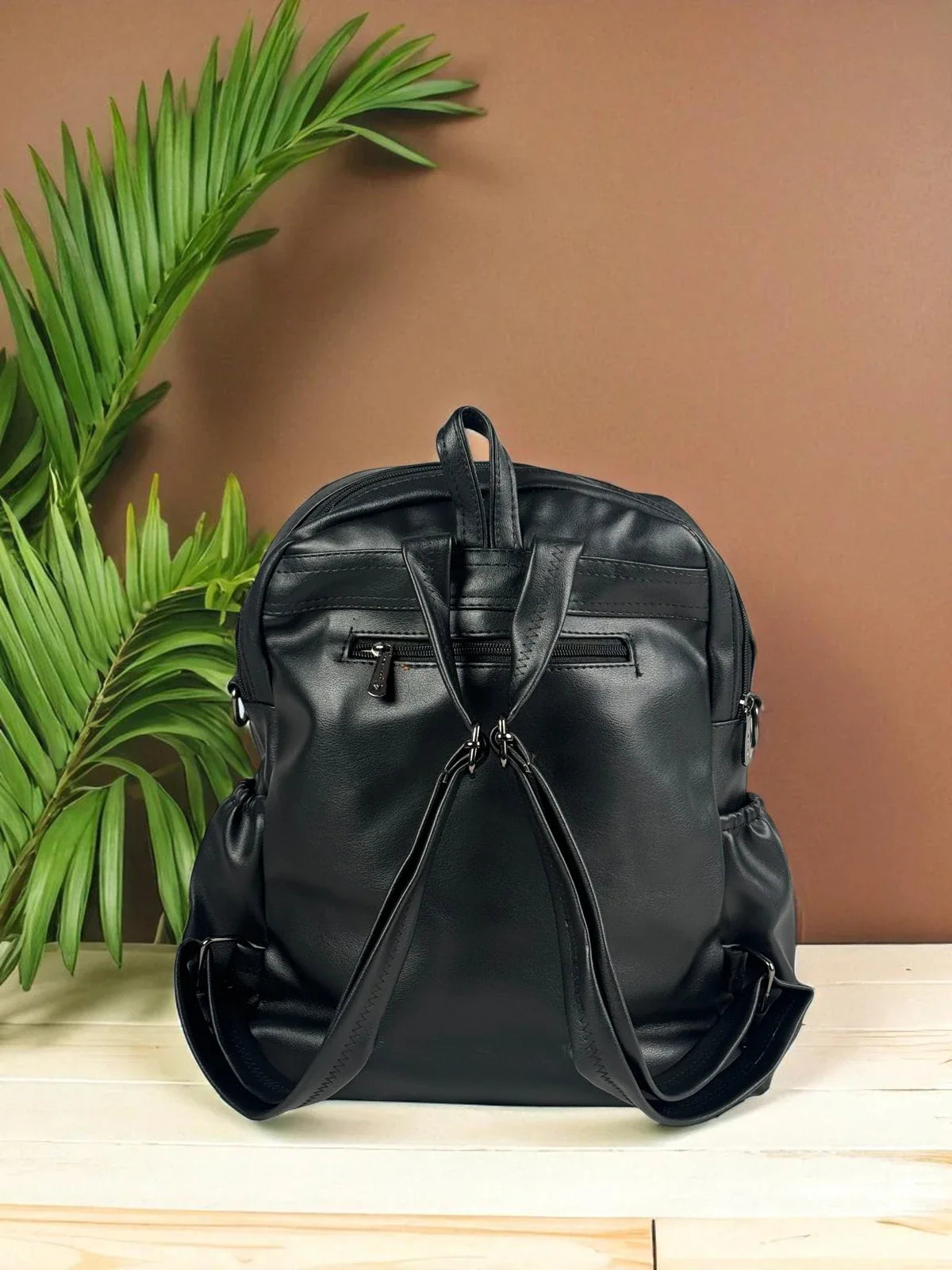 Tarani black PU leather backpack back view with stylish straps and zipper pocket