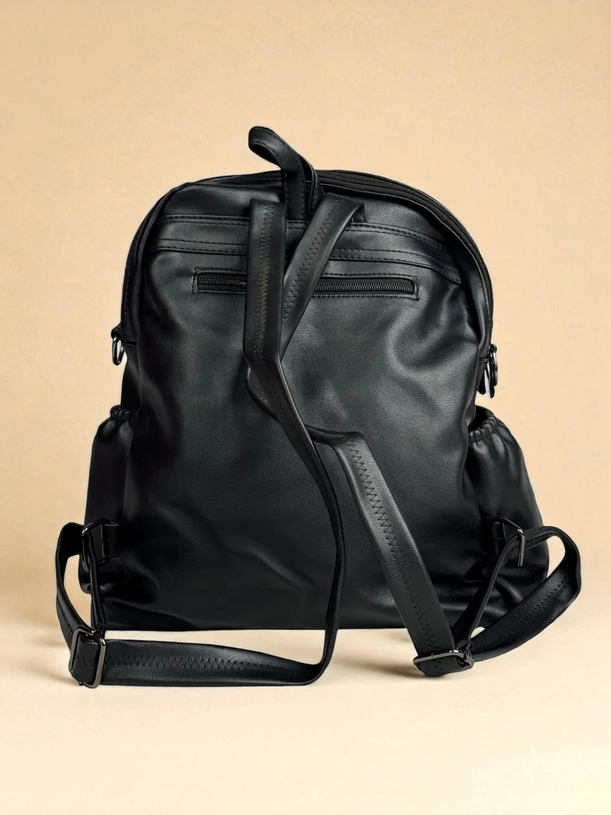 Tarani black PU leather backpack back view with straps and zip pocket
