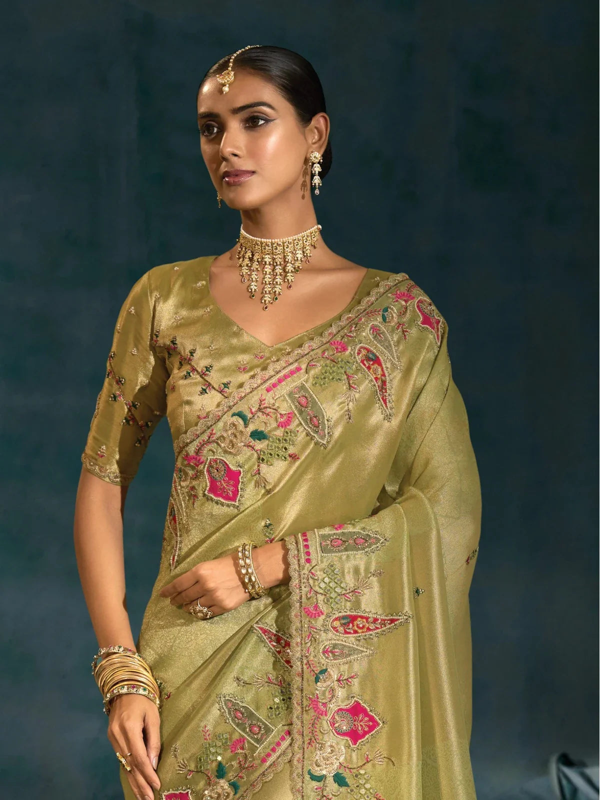 Tarani green banarasi saree upper body view styled with silk blouse and golden jewellery