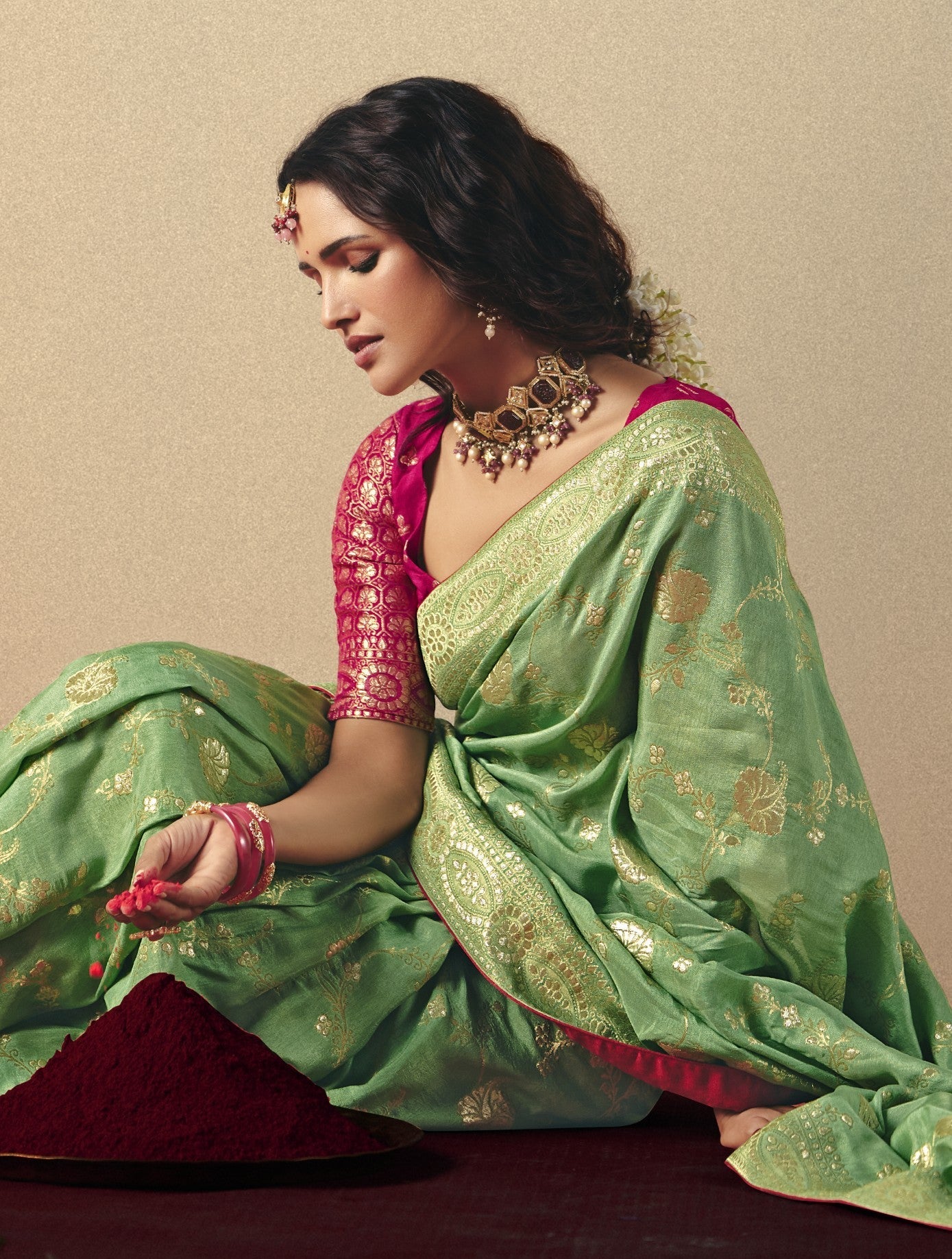 Tarani green bemberg viscose saree front view styled with pink weaving blouse and golden border