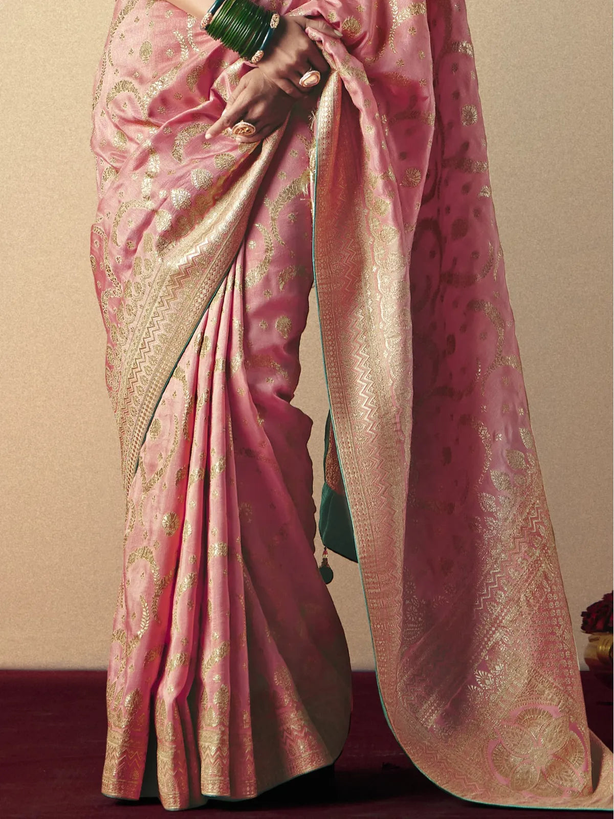 Tarani pink viscose saree pallu view with rich golden border and tassels