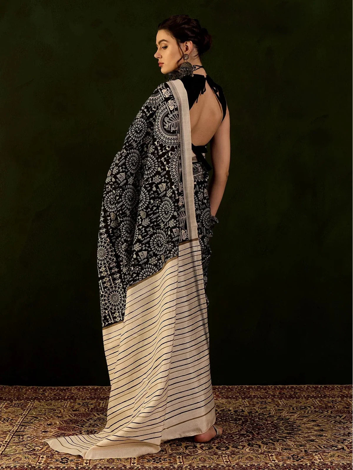 Tarani Bhagalpur black saree back view showing beige striped pallu and elegant drape