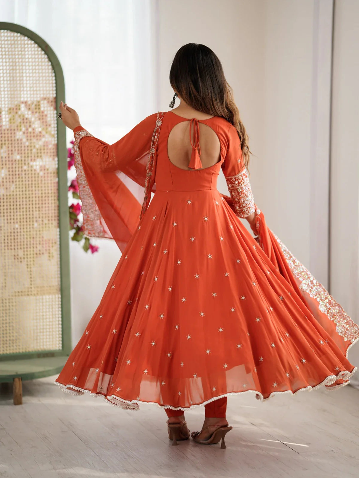 Tarani orange blooming faux anarkali dress back view highlighting tie-up detail and flare