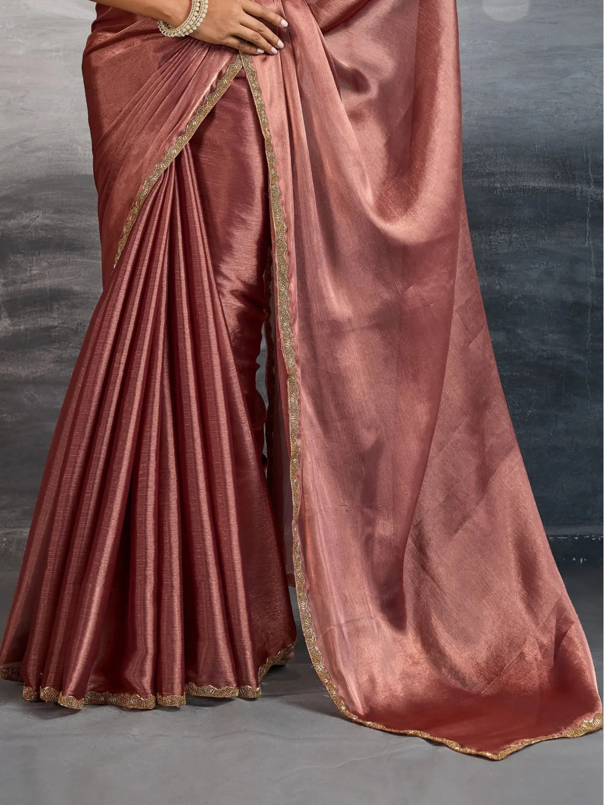 Tarani brown chiffon saree pallu and pleats view with elegant lace border for festive events