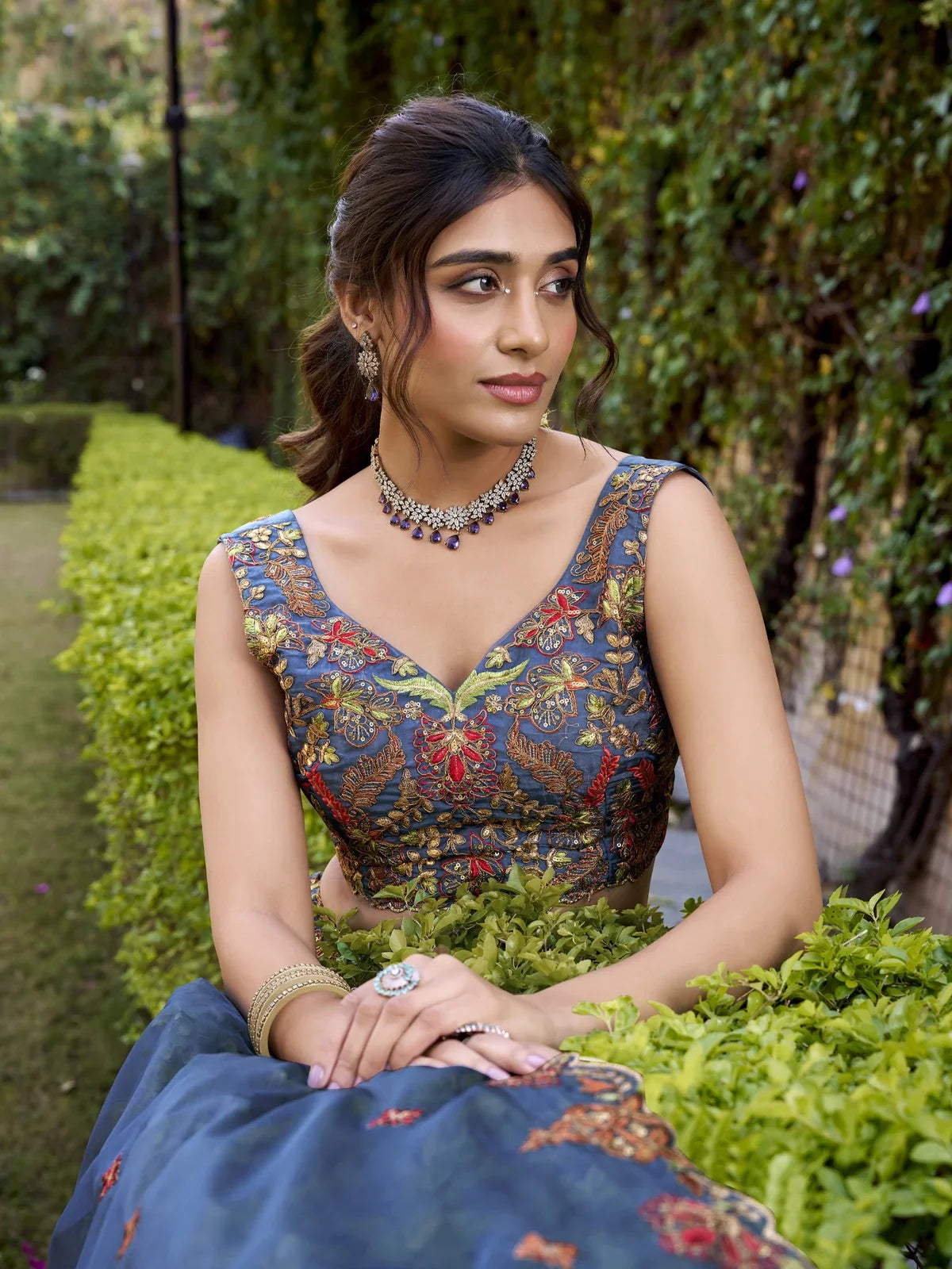 Tarani chanda silk lehenga upper body view showing detailed blouse embroidery with necklace and earrings