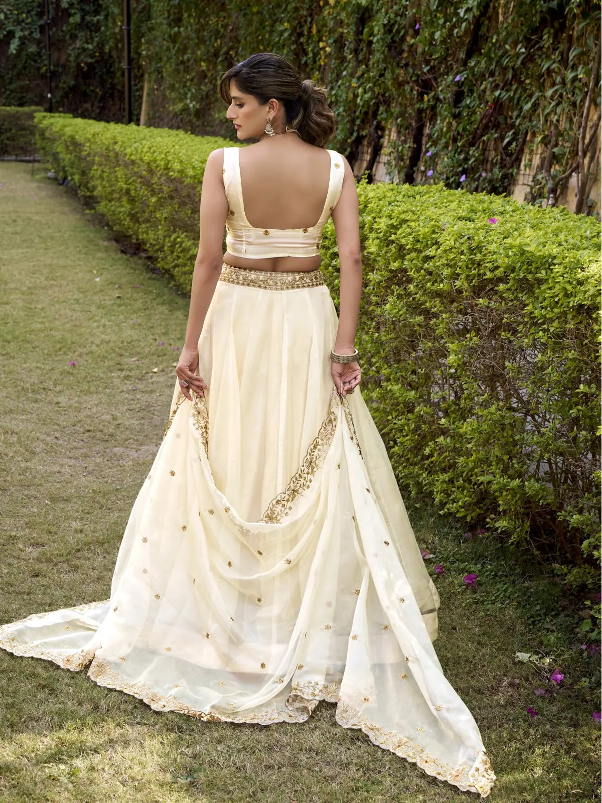 Tarani Chanda Silk cream lehenga with deep cut back blouse and flowing dupatta back view