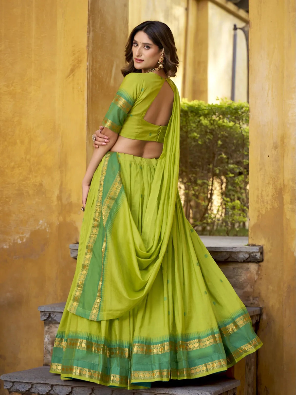Tarani green lehenga from back with classic drape and blouse detailing in zari chanderi fabric