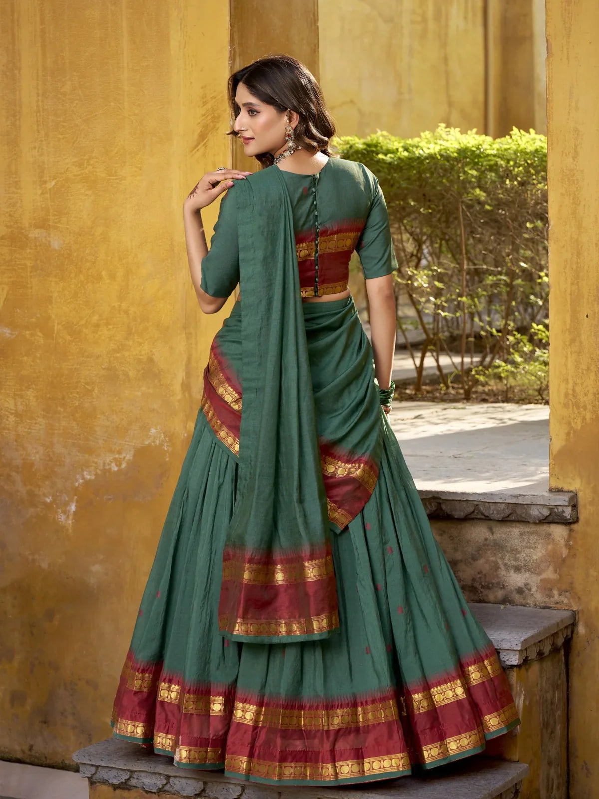 Tarani back view of green chanderi lehenga with contrast border and dupatta