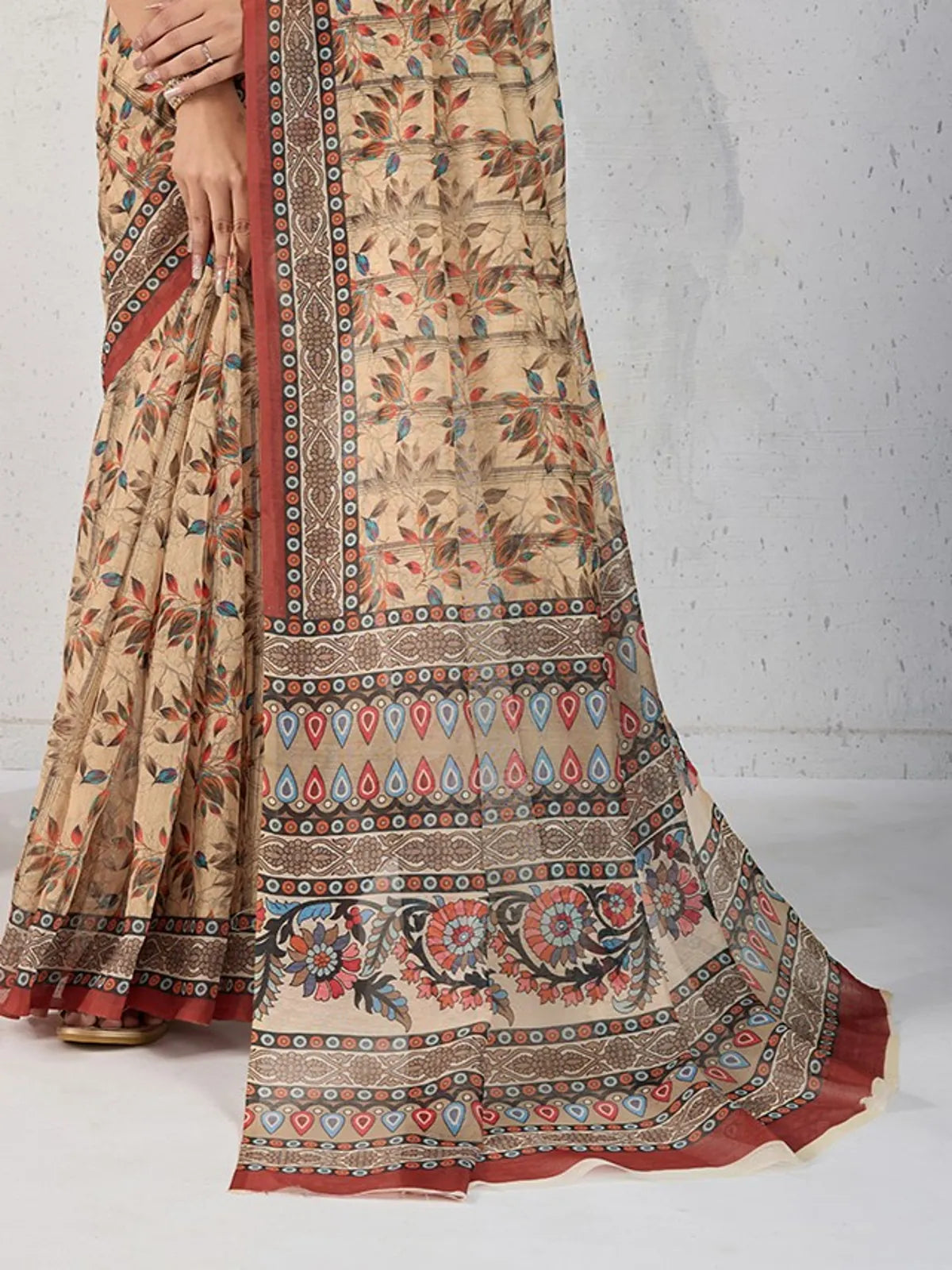 Tarani Chanderi saree closeup showing intricate floral motifs and border patterns on beige fabric