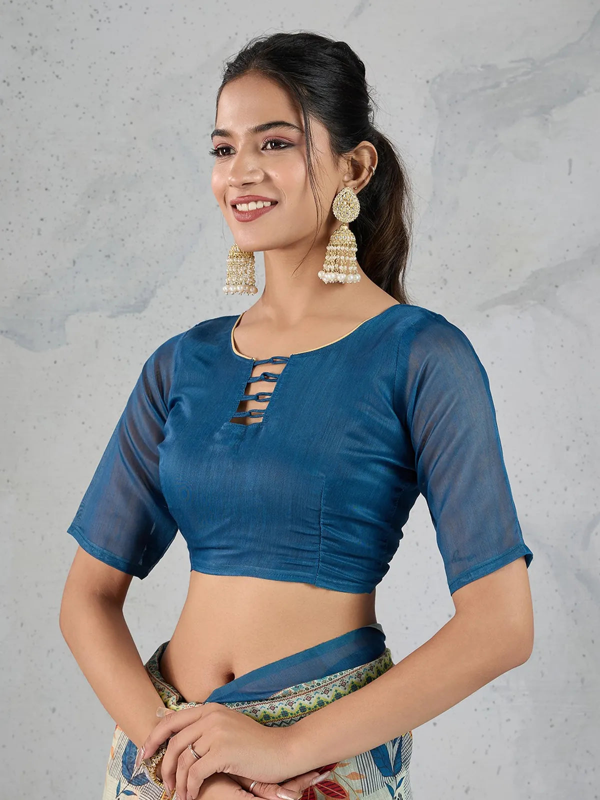 Tarani saree upper body view showing blue blouse with modern neckline and transparent half sleeves