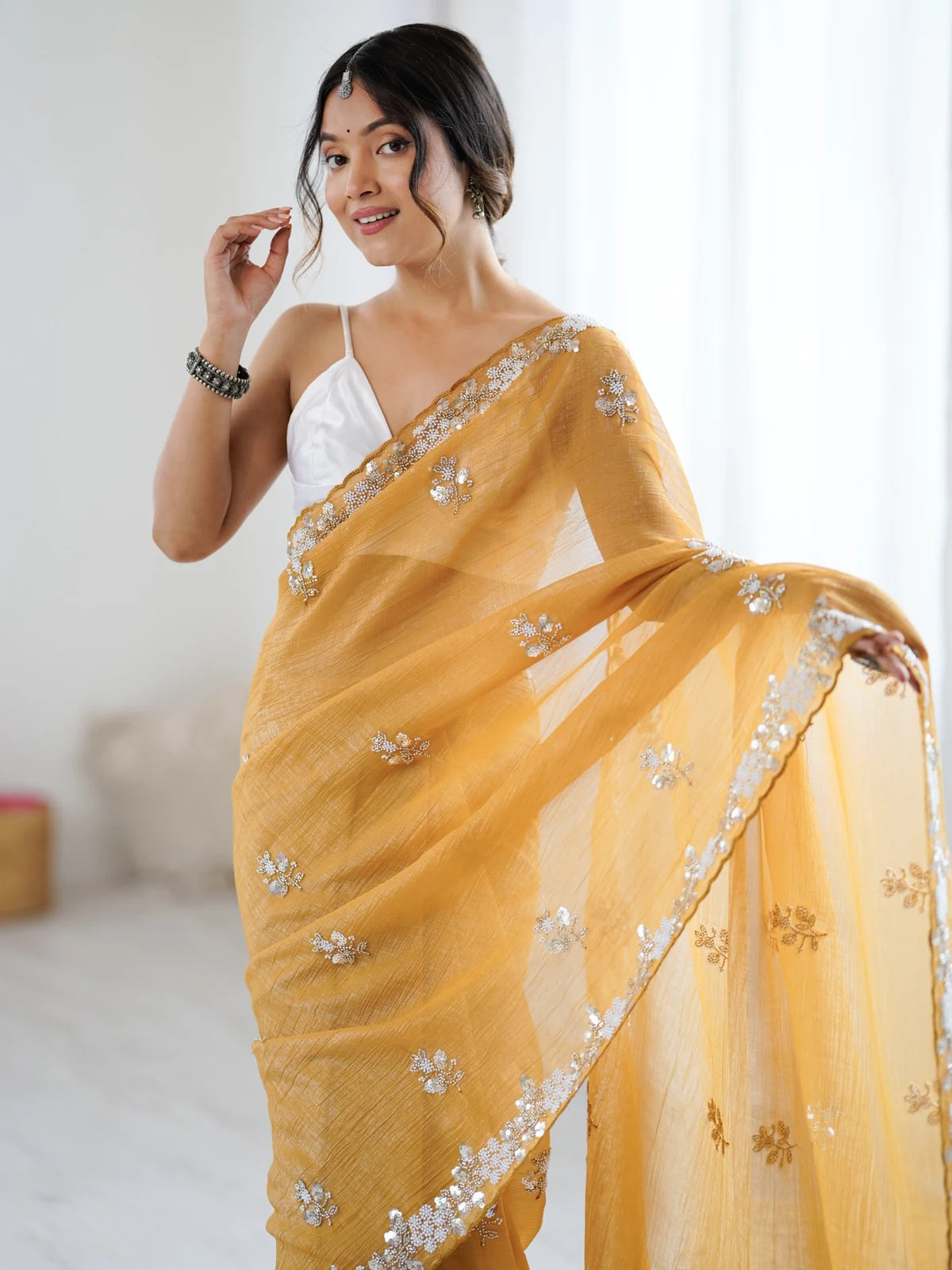 Tarani Amishi mustard chiffon crush saree upper body view with embellished border