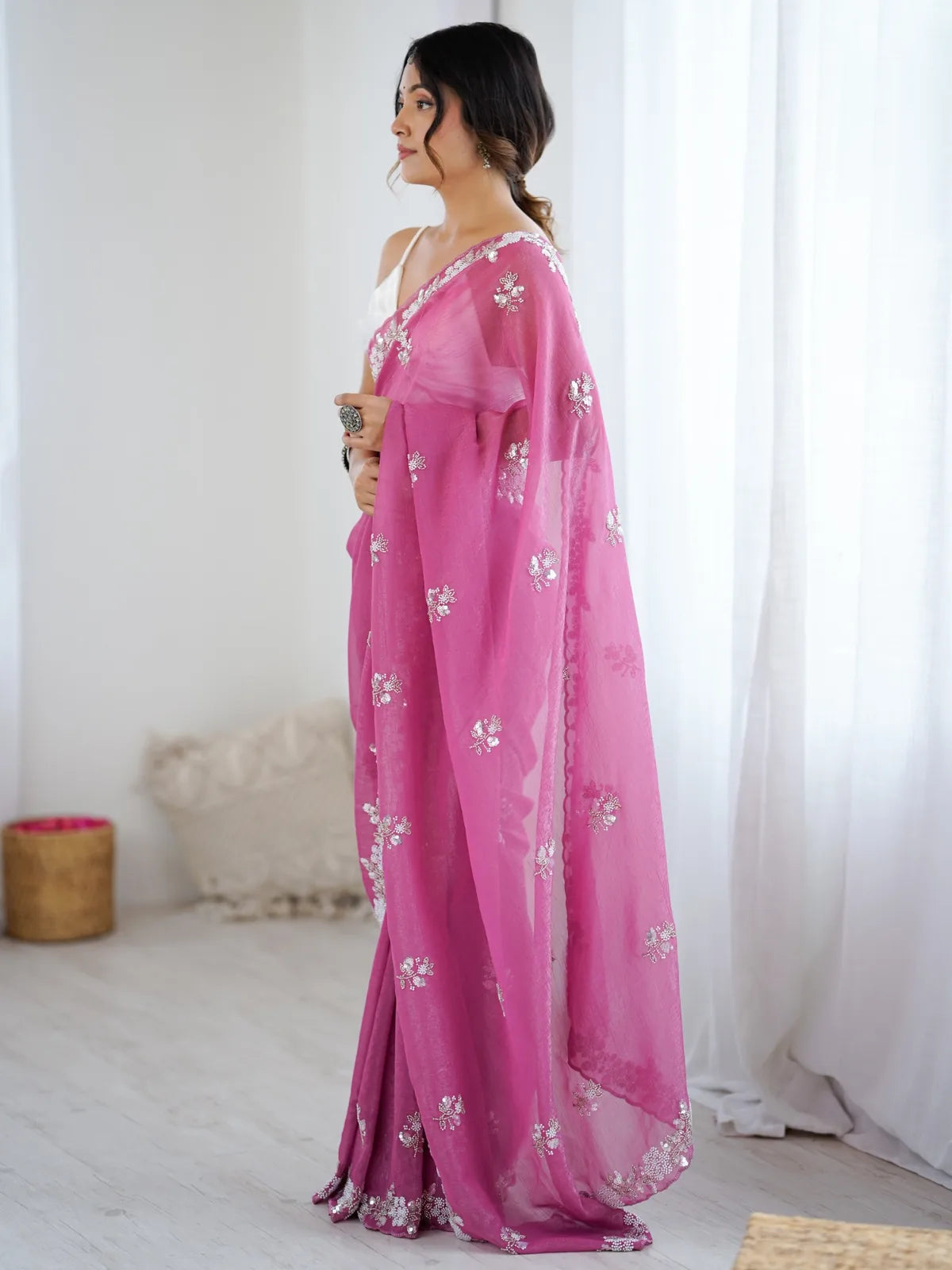 Tarani Mugdha pink chiffon crush saree side view showcasing pallu border and graceful silhouette
