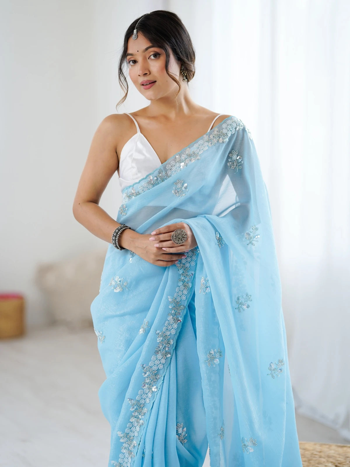 Tarani sky blue chiffon crush saree upper body view with embroidered border and elegant drape
