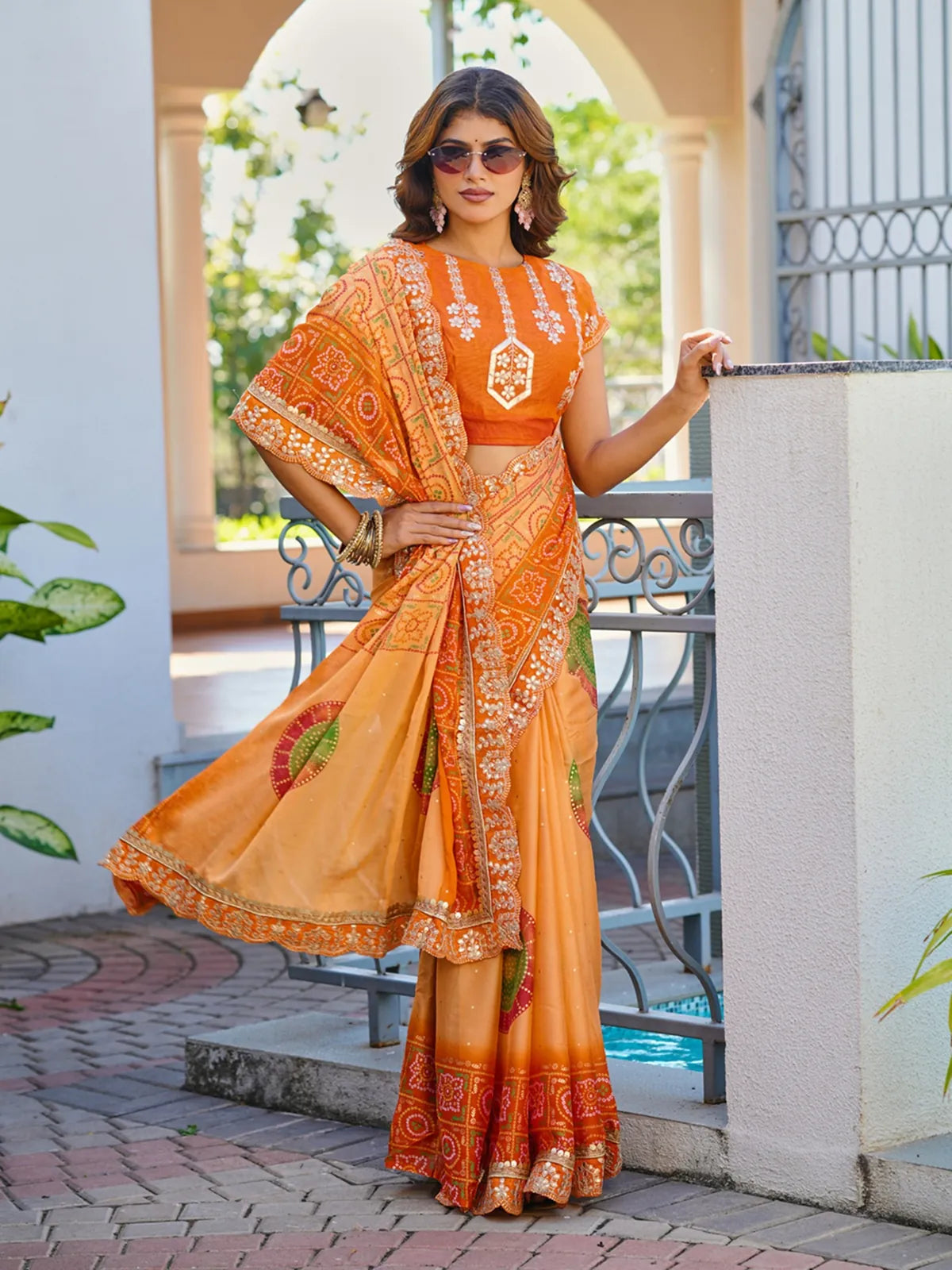 Tarani premium orange chiffon saree with full view showing festive look and detailed pallu