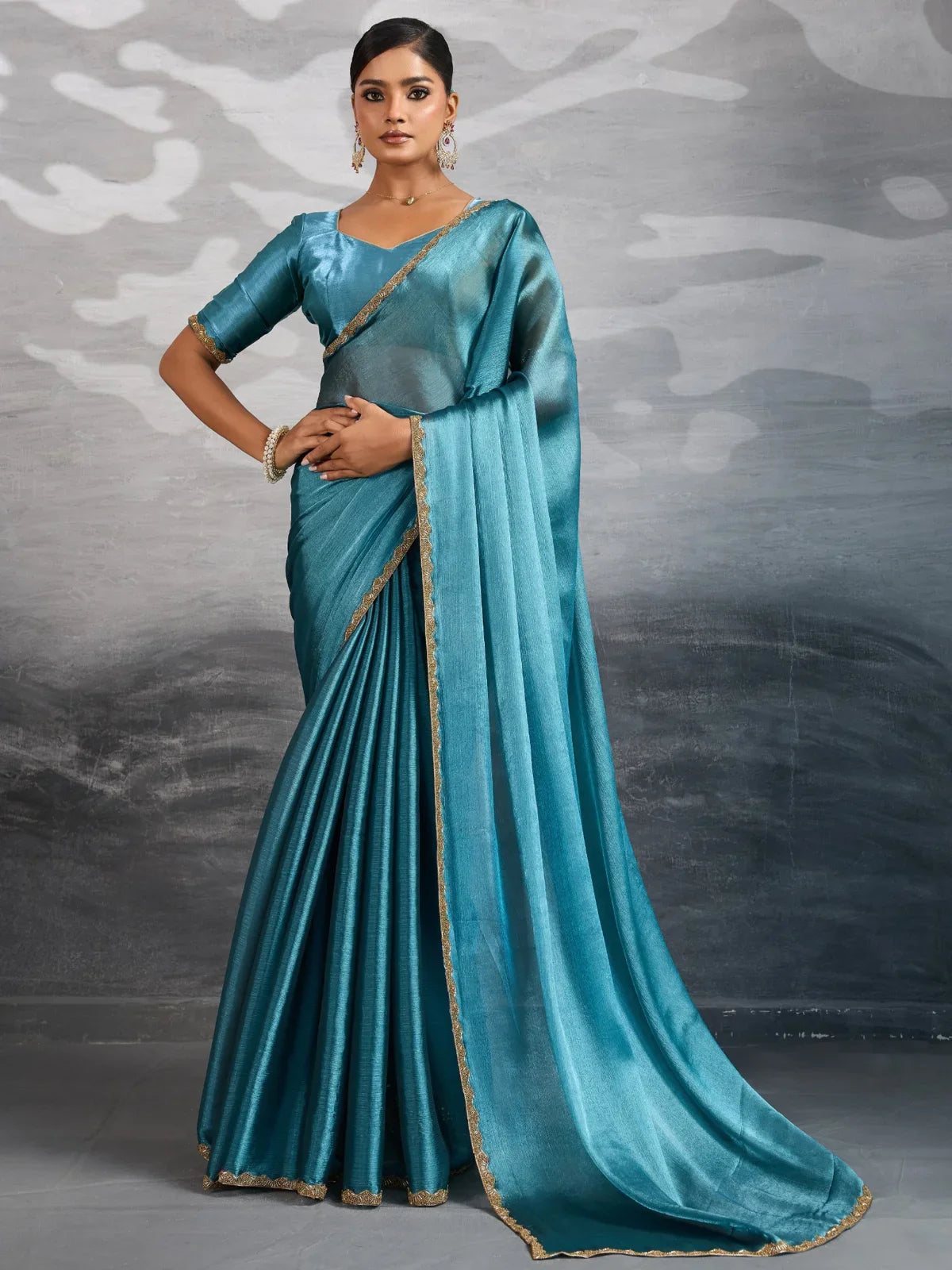 Tarani teal chiffon saree front view with beaded cutdana lace border and running blouse with lace sleeves