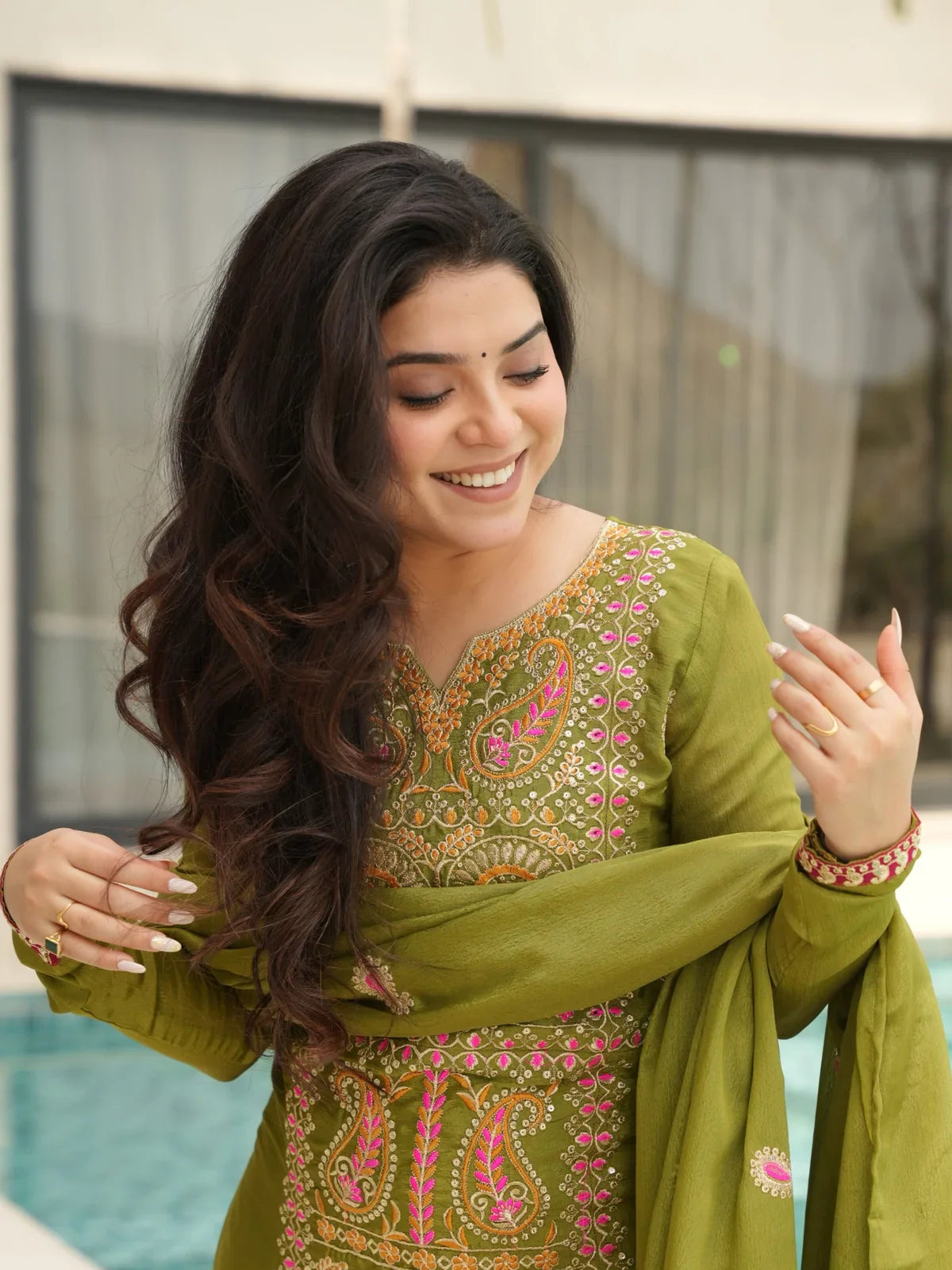 Upper body view of Tarani green Chinnon dress with round neck and full sleeve embroidery