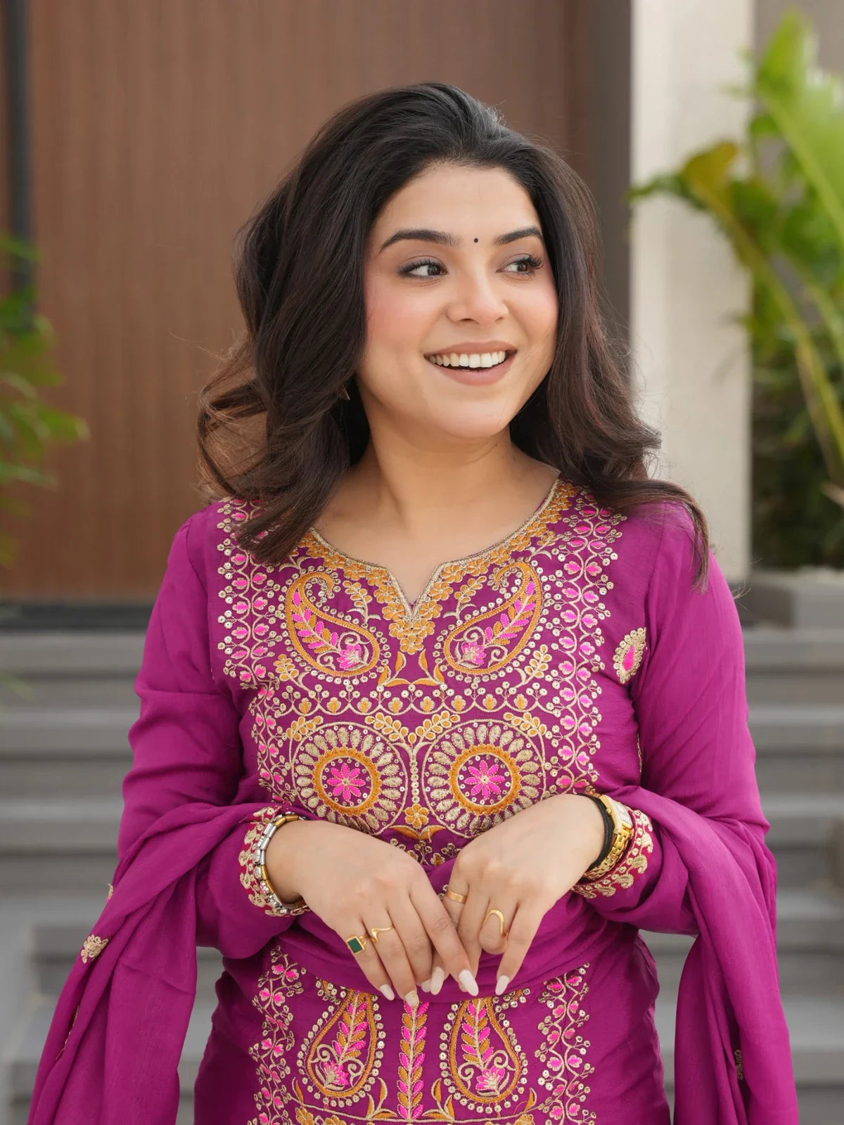 Tarani magenta chinnon embroidered dress showing close-up neckline and zari work