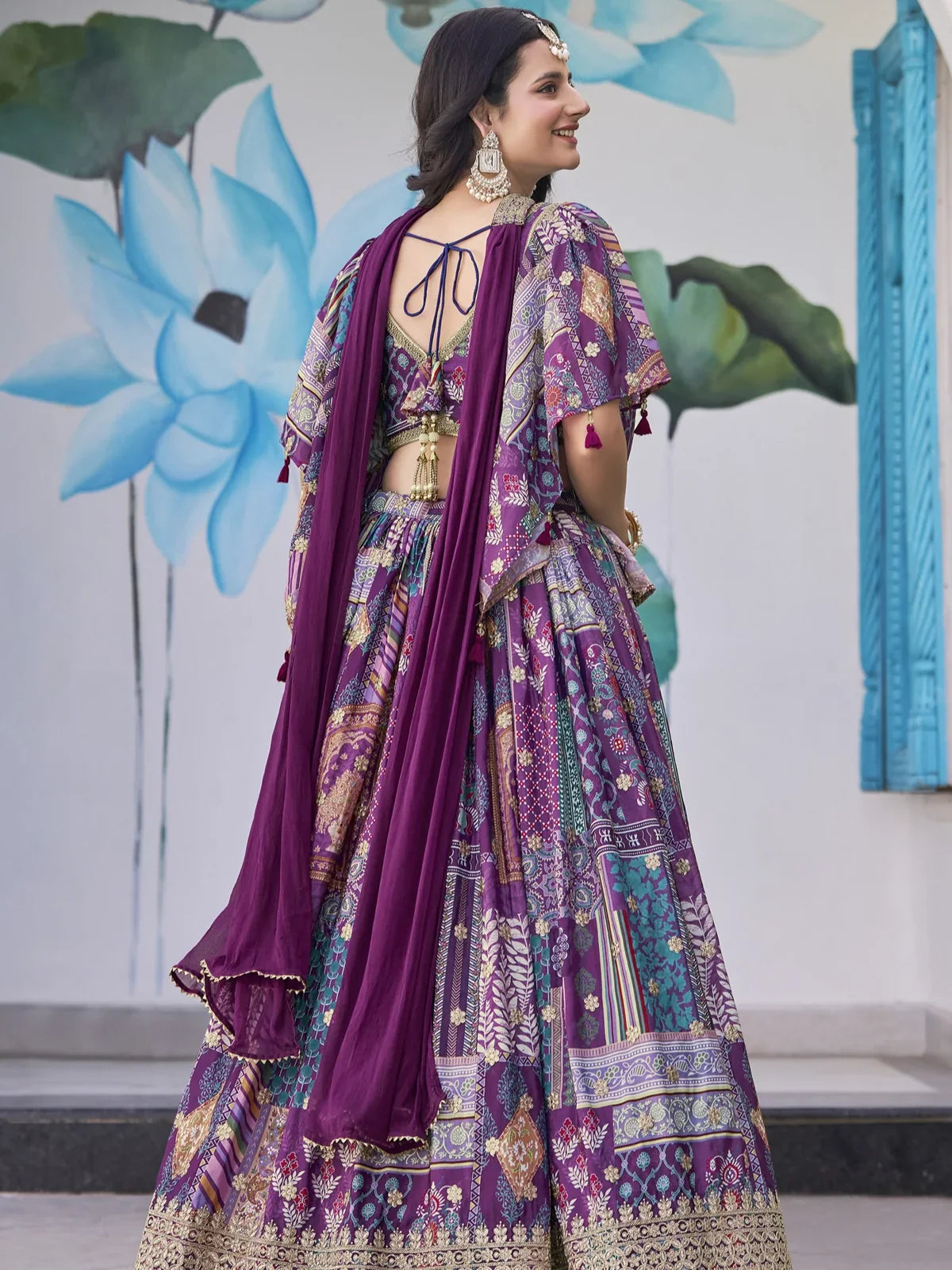 Tarani purple chinnon lehenga back pose showing blouse tie-up design and dupatta drape