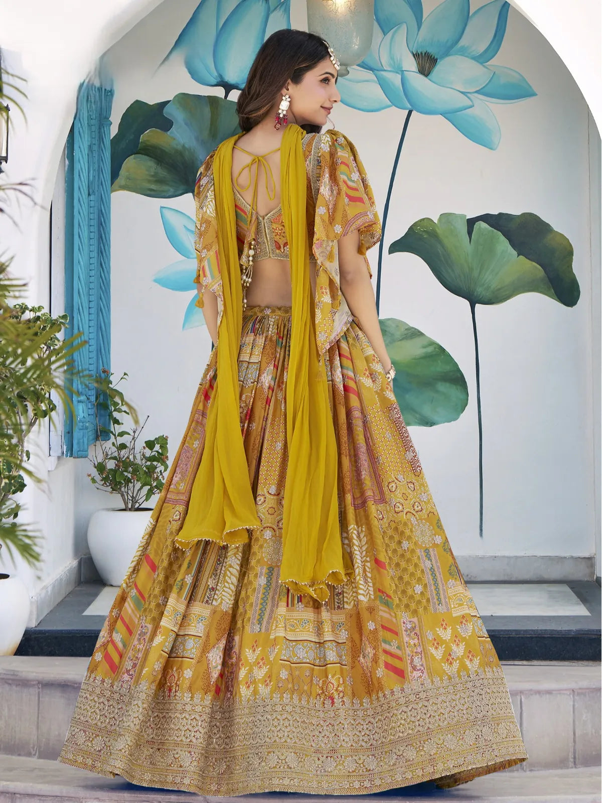 Tarani back view of yellow chinnon lehenga showing dupatta and blouse tie-up style