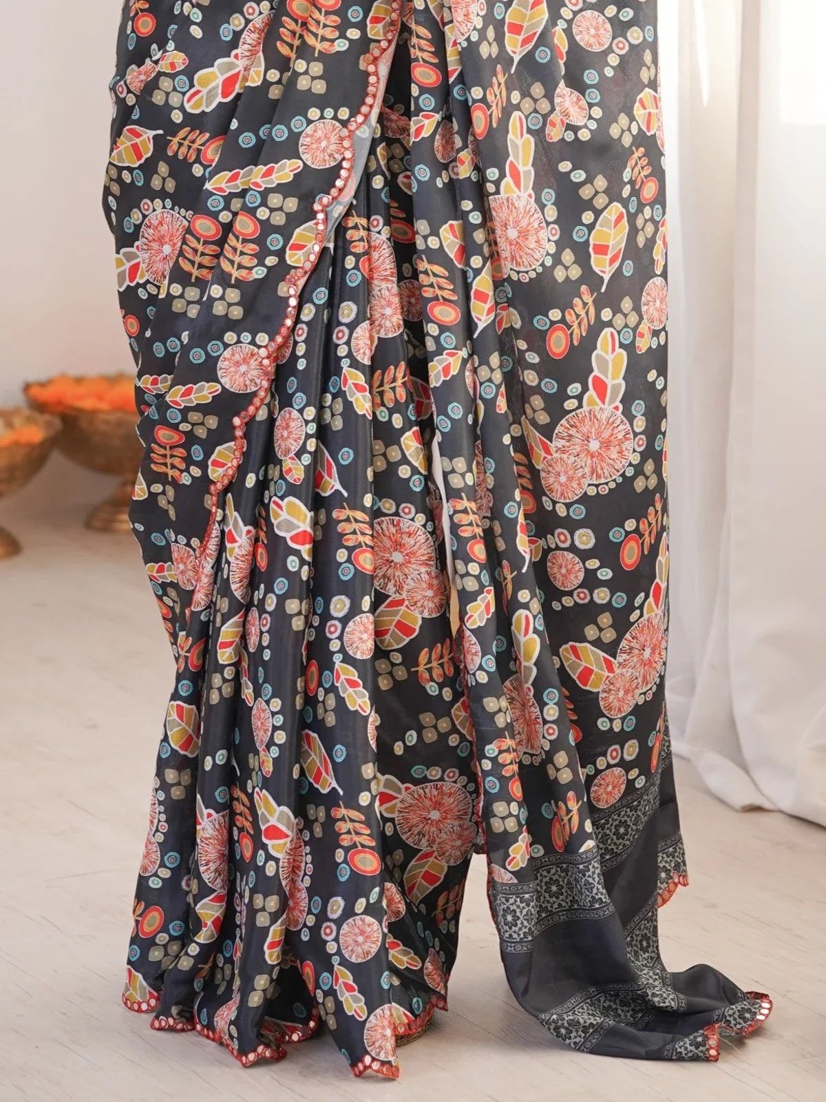 Tarani chinnon saree closeup showcasing colorful print and mirror work detailing