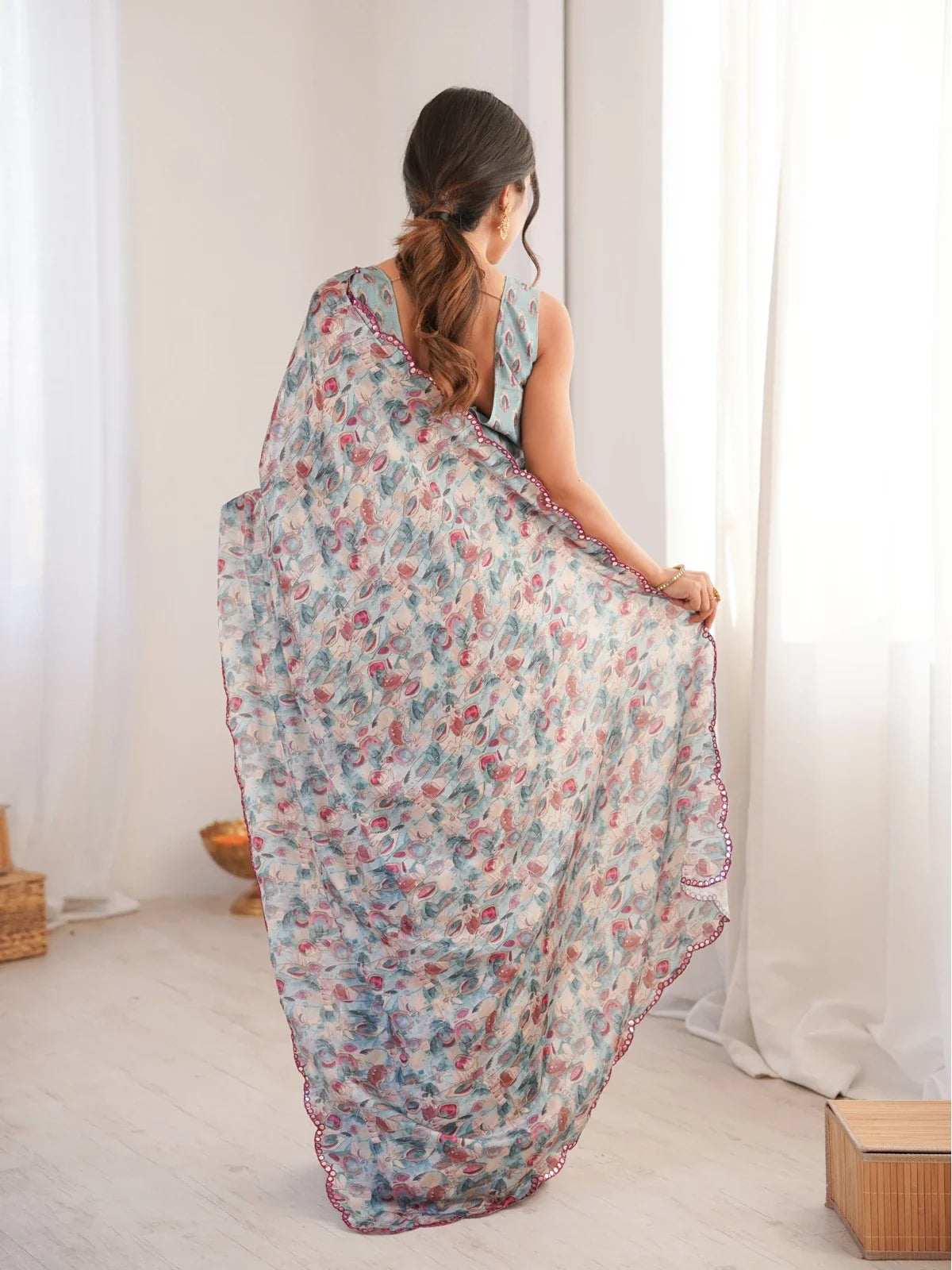 Back pose of Tarani blue printed chinnon saree