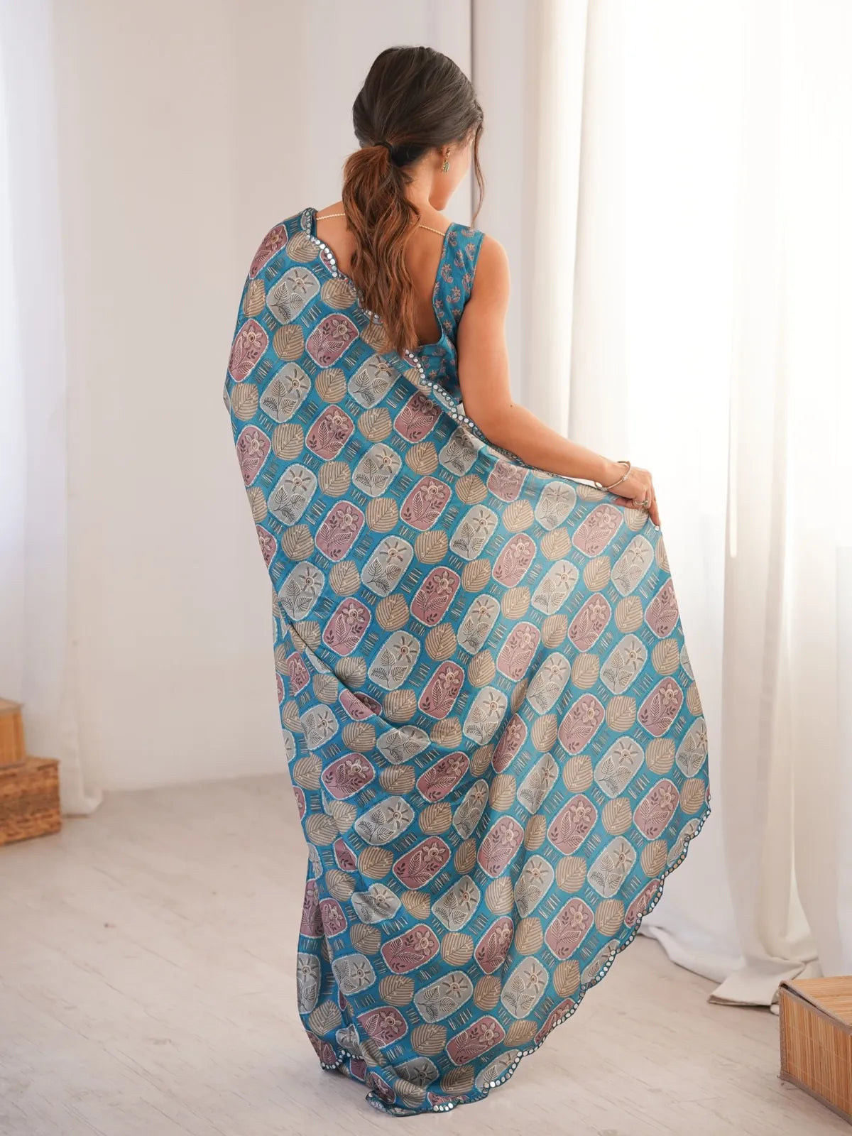 Tarani saree back view showing overall drape fall and mirror border finish
