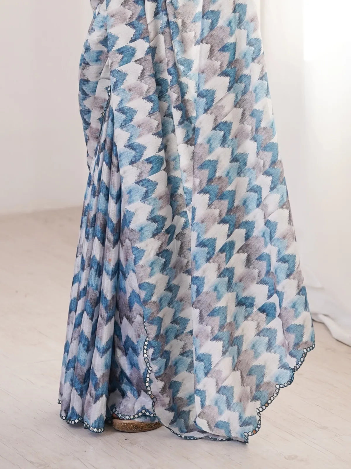 Tarani closeup of blue chinnon saree with beautiful mirror outing and print detailing