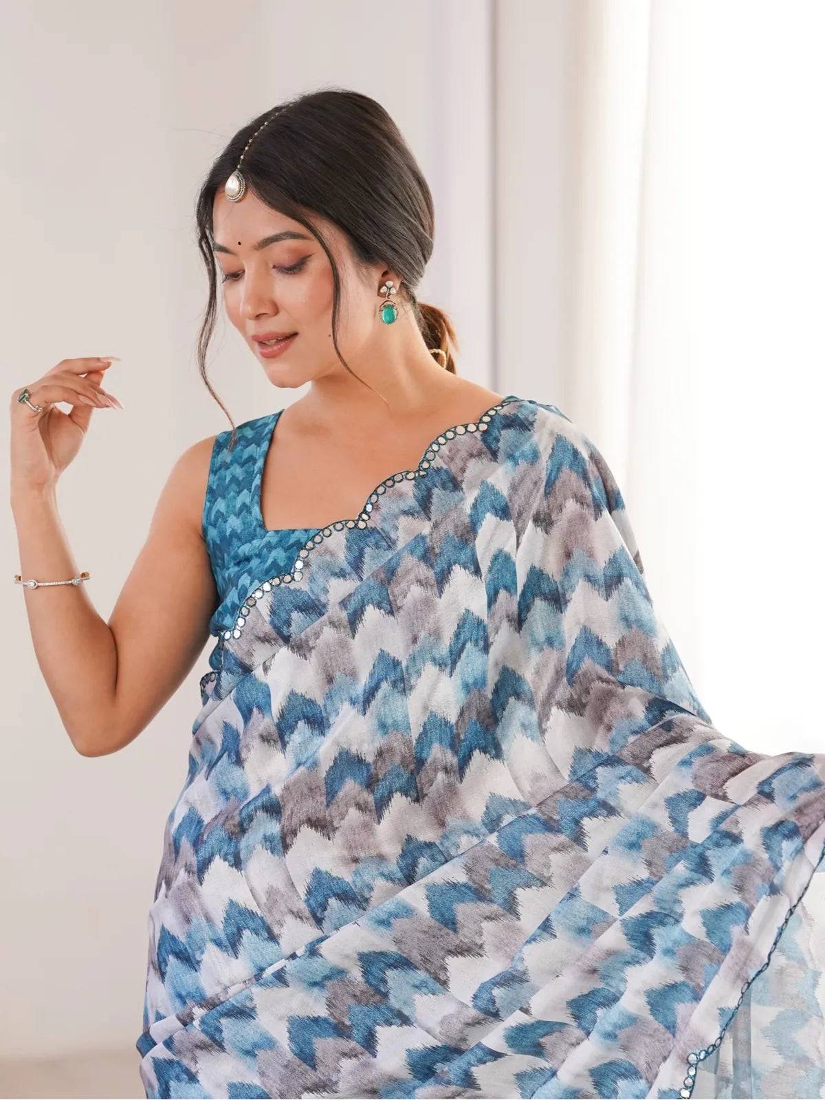 Tarani chinnon saree in blue with mirror work border and printed blouse upper body view