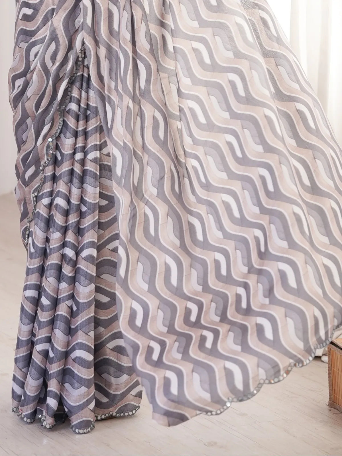 Tarani saree pallu close-up with flowing mirror border and abstract wave print