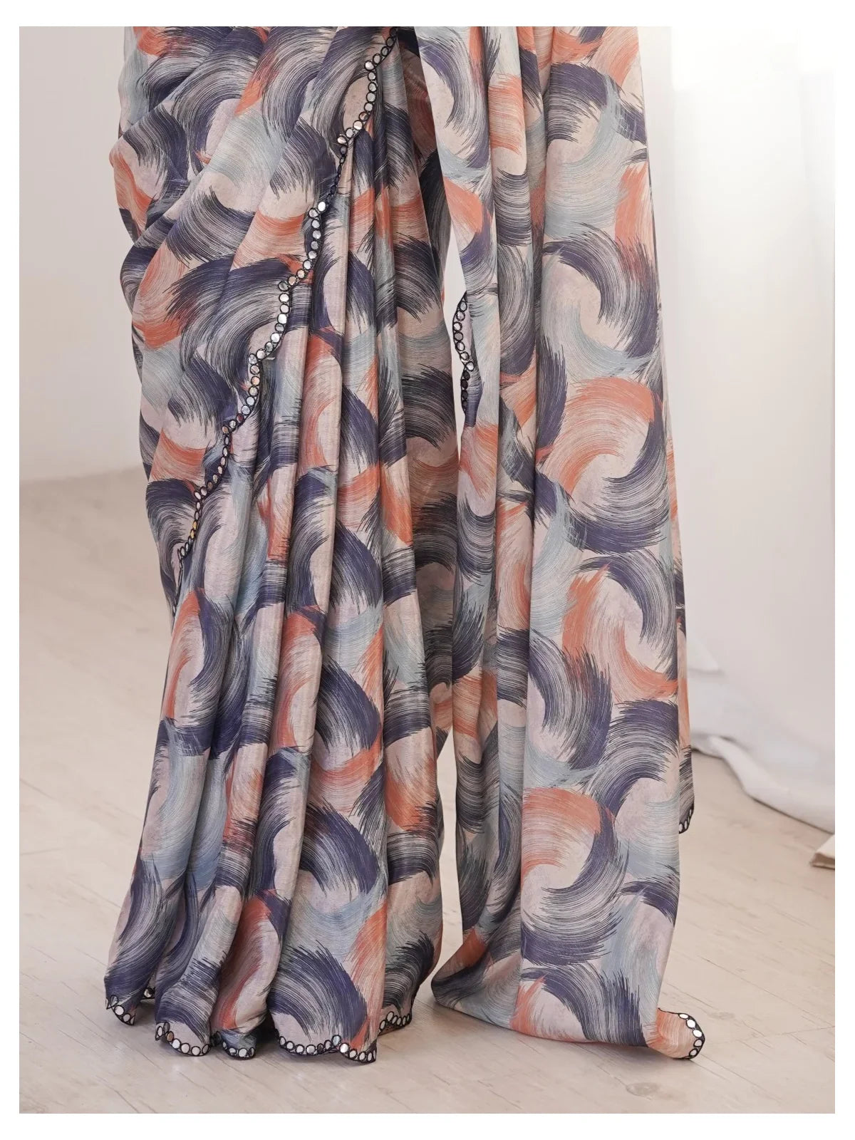 Tarani close-up of multicolor swirl design on soft chinnon fabric with mirror border