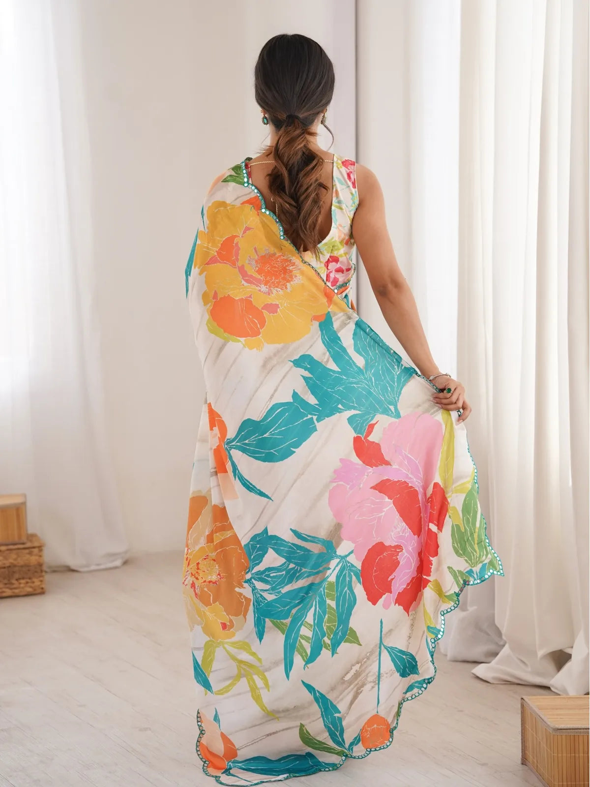 Tarani off white floral chinnon saree back view with flowing pallu