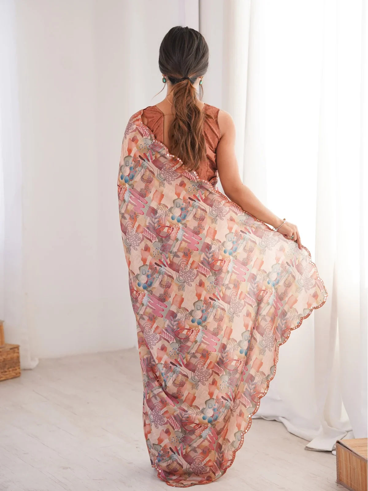 Tarani peach printed chinnon saree back view view showing design and drape