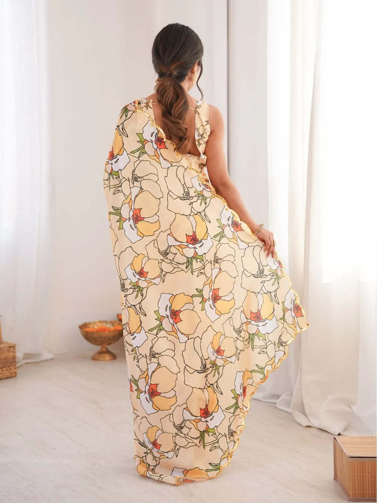 Tarani peach chinnon saree with back view showcasing printed floral design and mirror work border