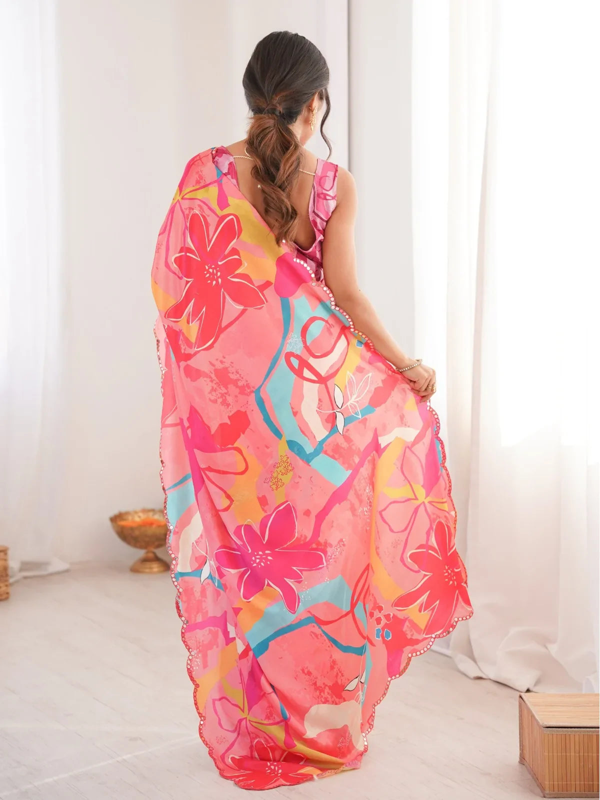 Tarani pink chinnon saree back view showing pallu fall and graceful drape