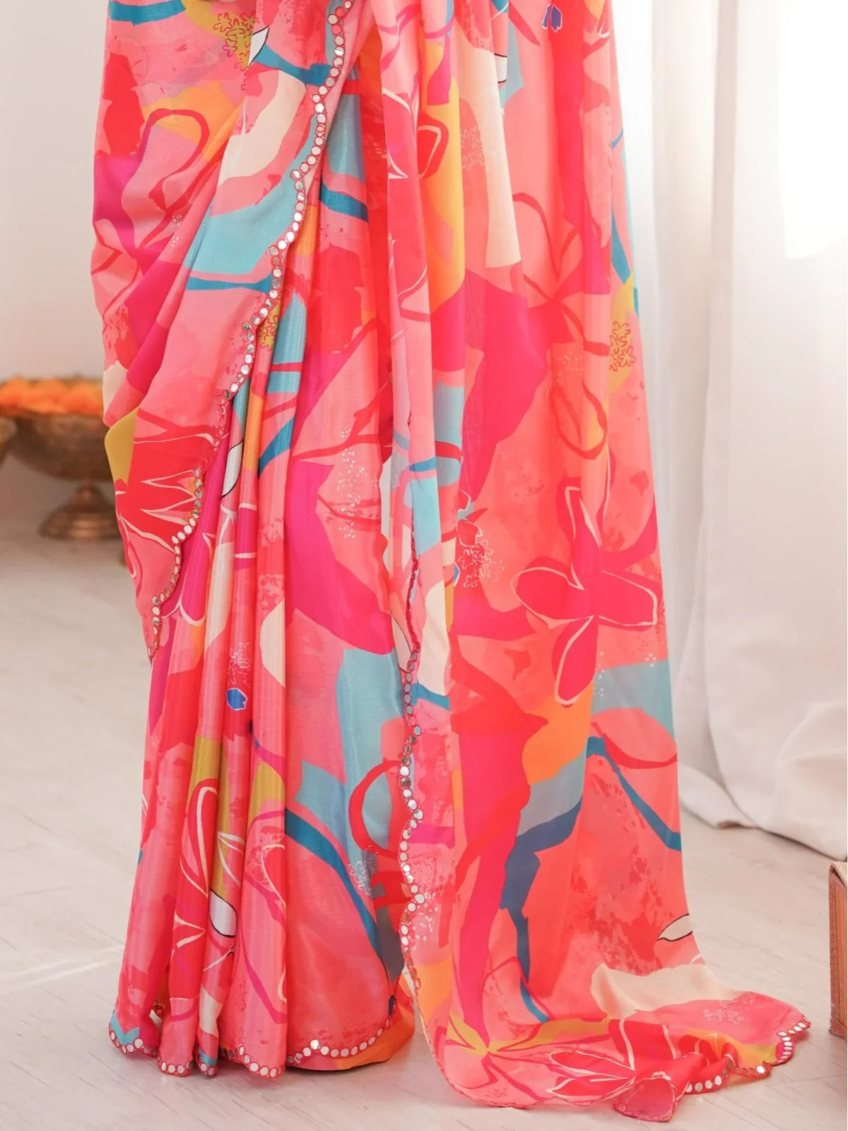 Tarani pink chinnon saree closeup showing detailed print and mirror border craftsmanship
