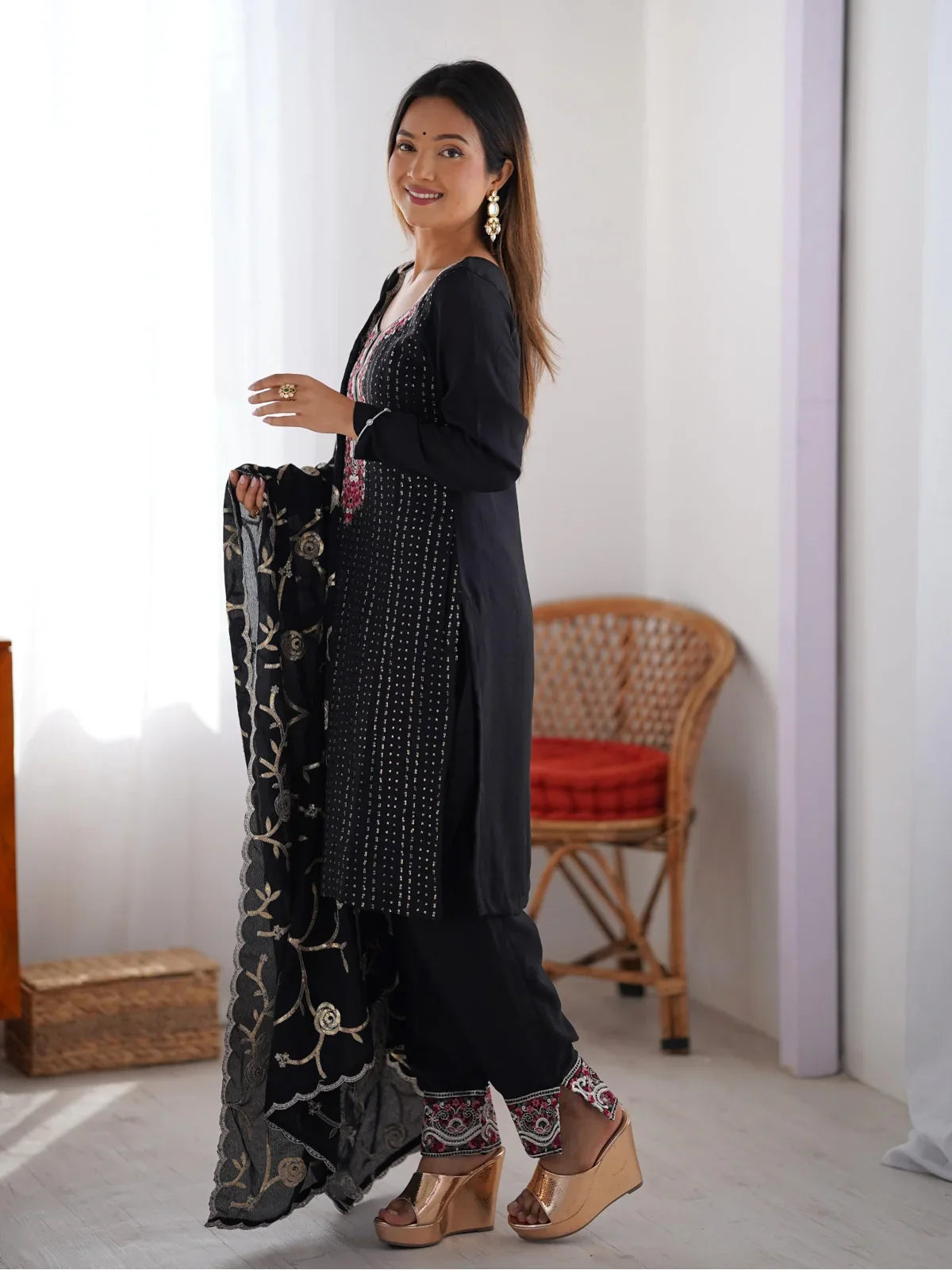 Tarani premium chinon silk dress in black showing side pose with detailed embroidery and festive styling